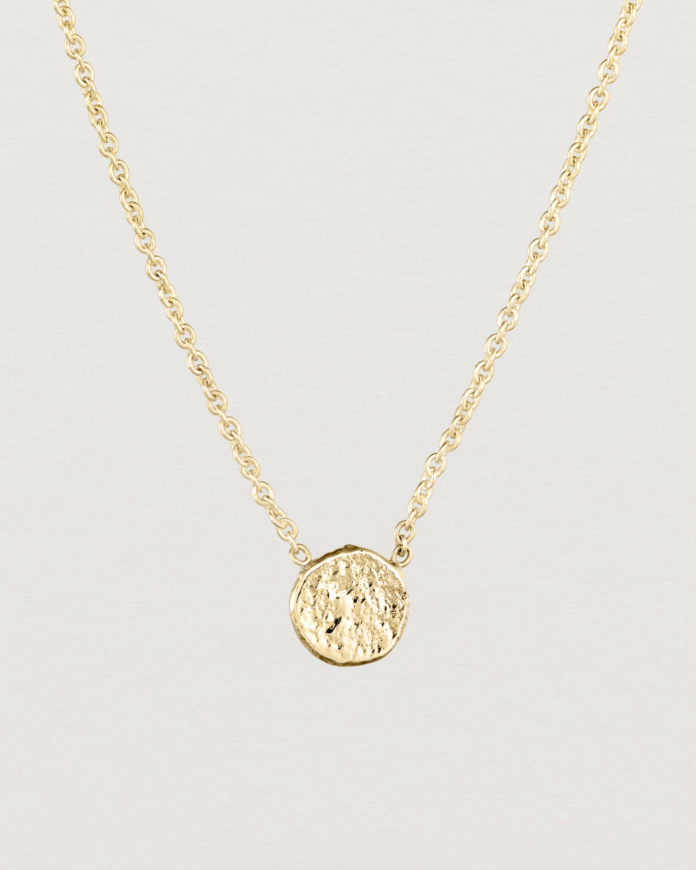 Close up view of the Moon Necklace in yellow gold.