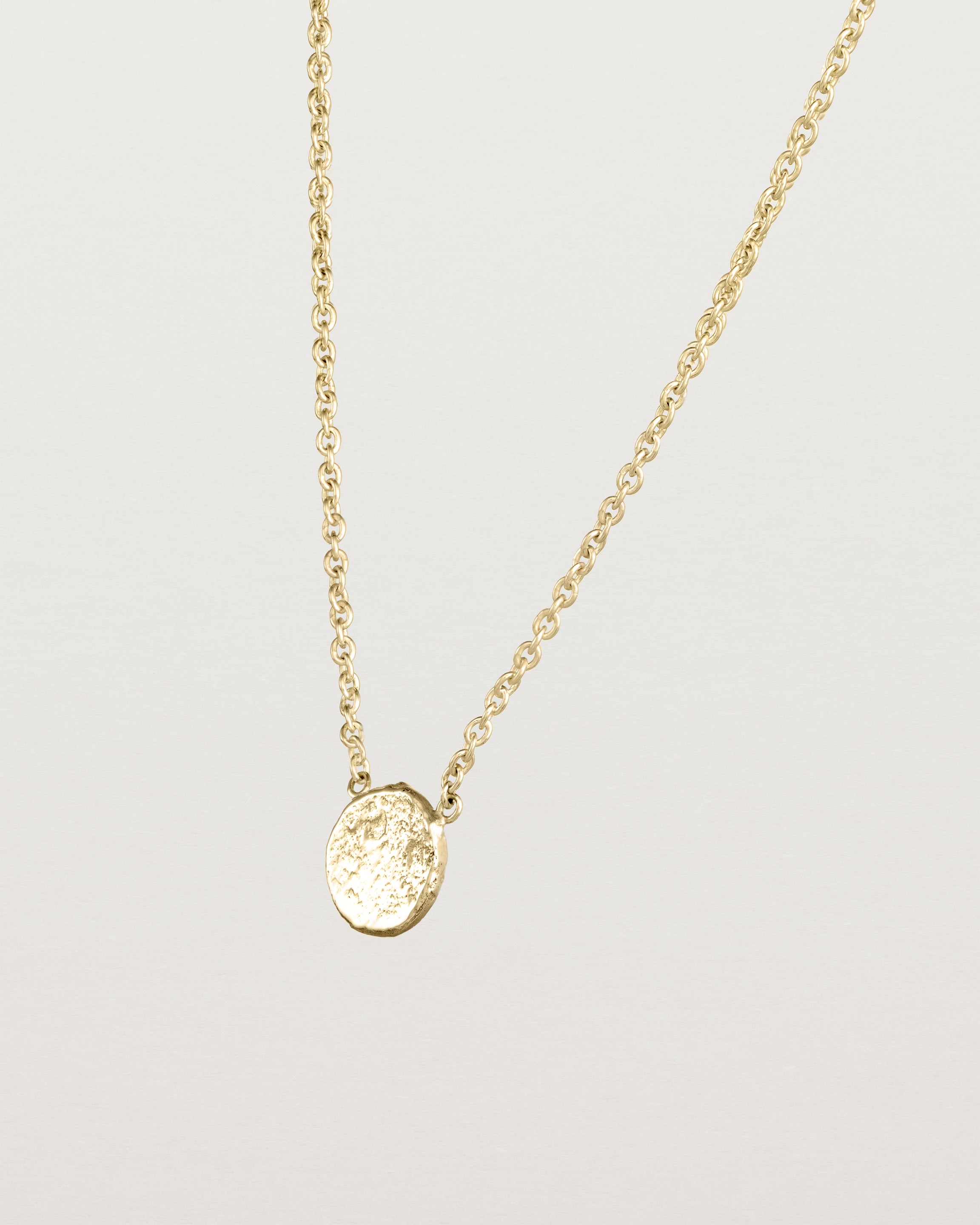 Angled view of the Moon Necklace in yellow gold.