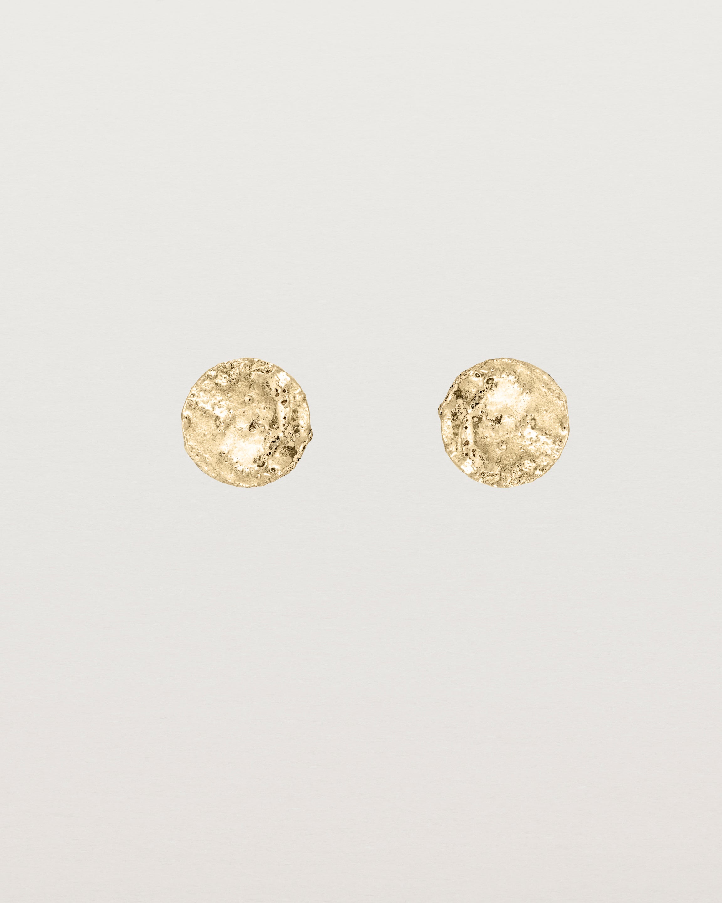 A pair of textured circular yellow gold studs