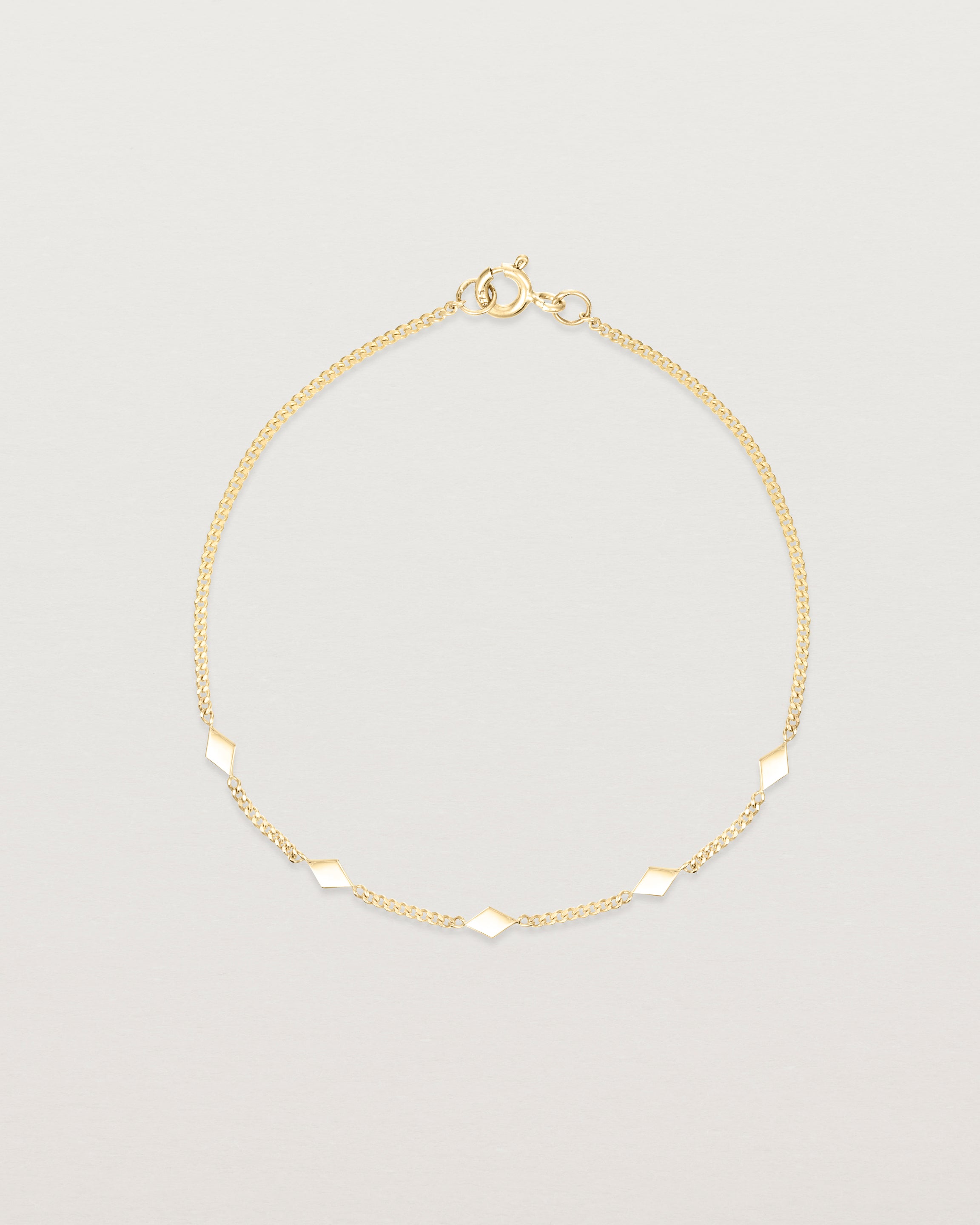 Top down view of the Nuna Charm Bracelet in Yellow Gold.