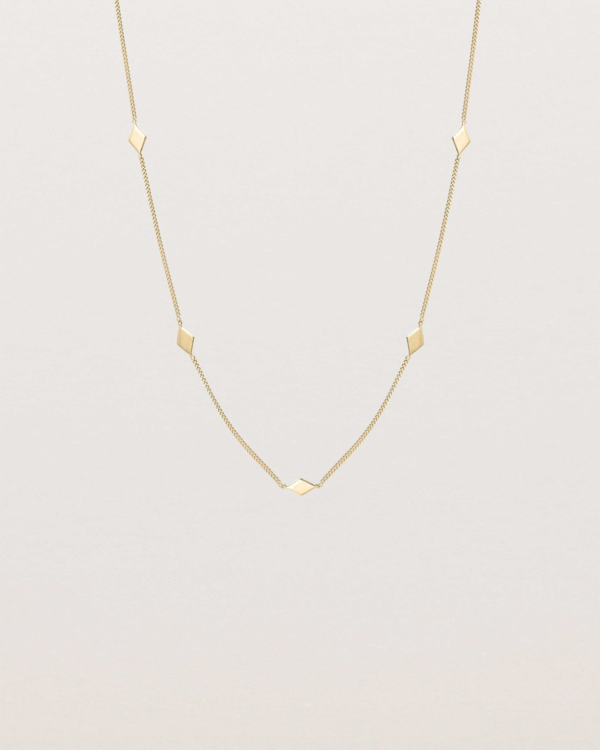 Front view of the Nuna Charm Necklace in yellow gold.