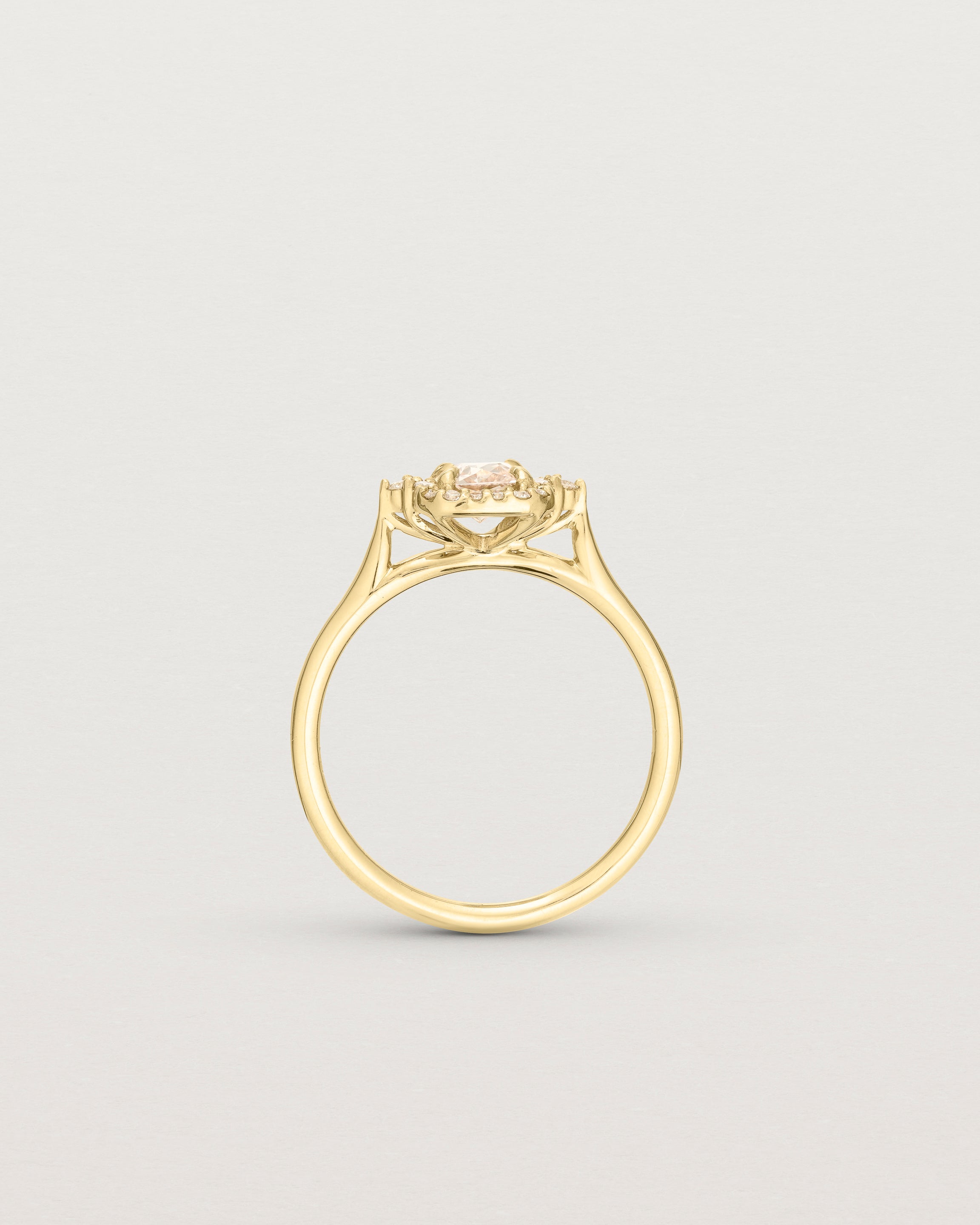 Side profile image of the winona ring with a peach sapphire in yellow gold.