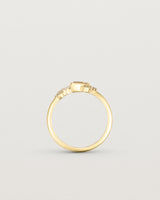 Product image of a yellow gold engagement ring with a rutilated quartz and diamonds, standing view.