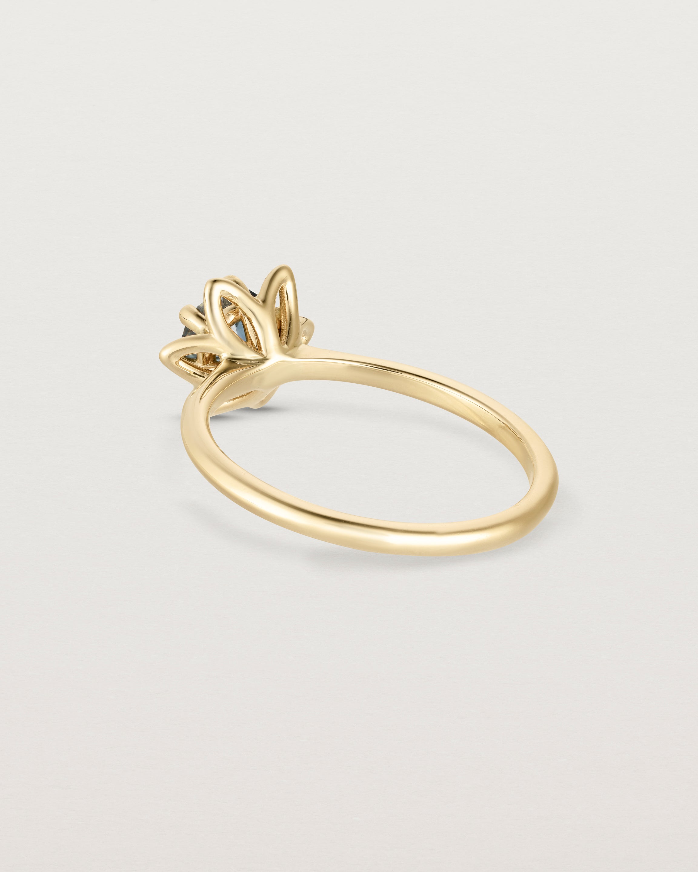 Back facing deep etched image of a Australian Teal Sapphire solitaire engagement ring.