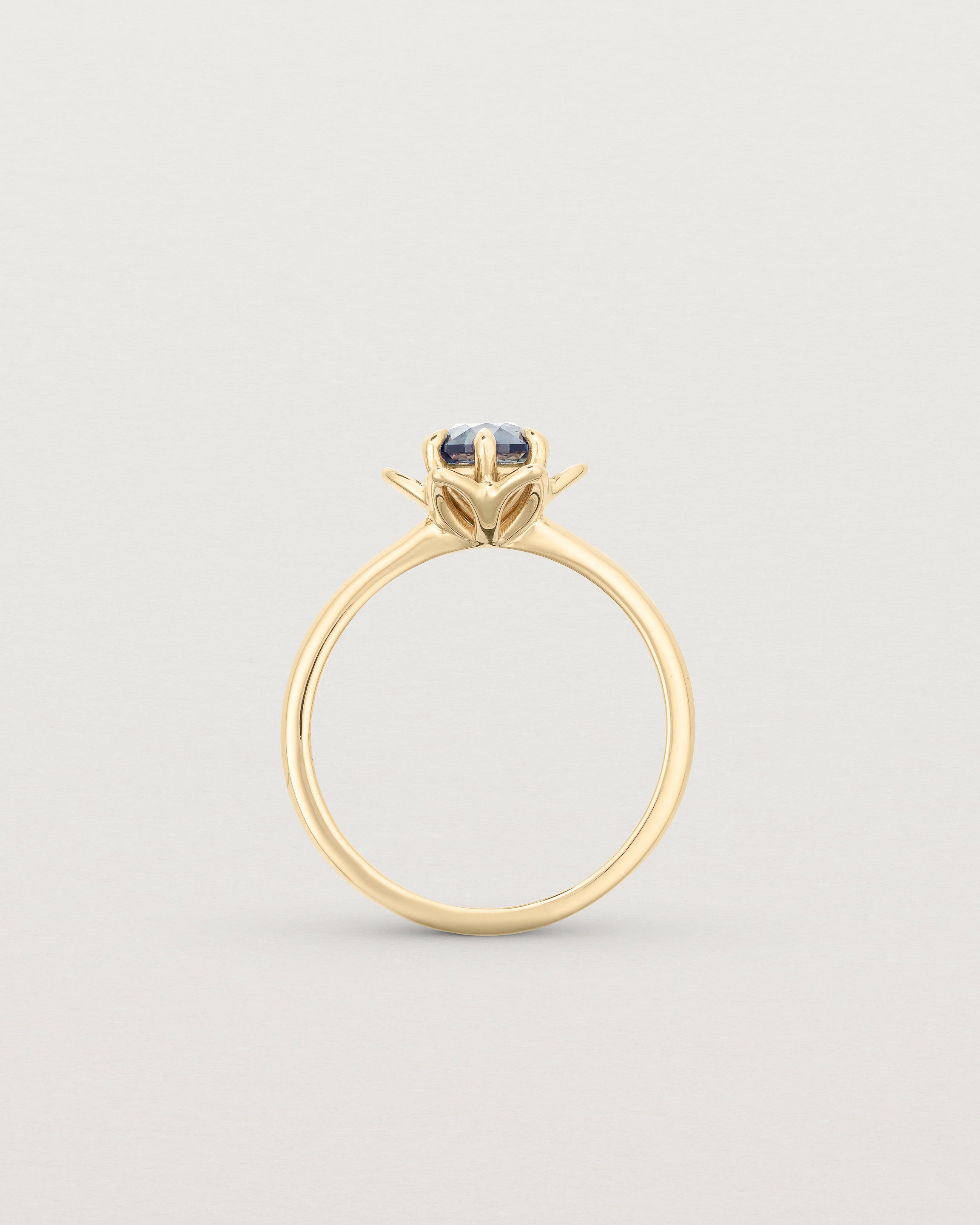 Standing deep etched image of a Australian Teal Sapphire solitaire engagement ring.