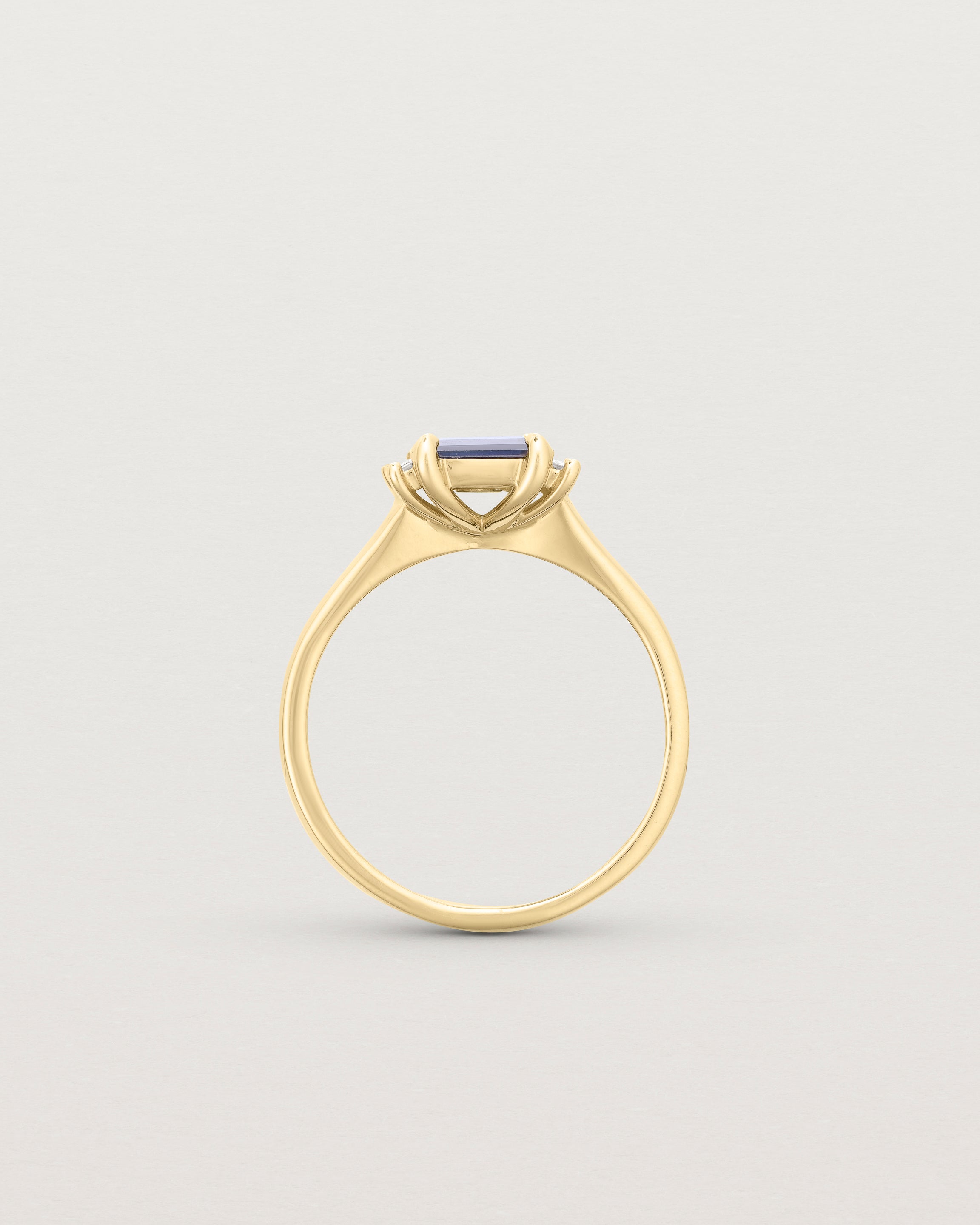 Standing deep etched image of a yellow gold trio design engagement ring.