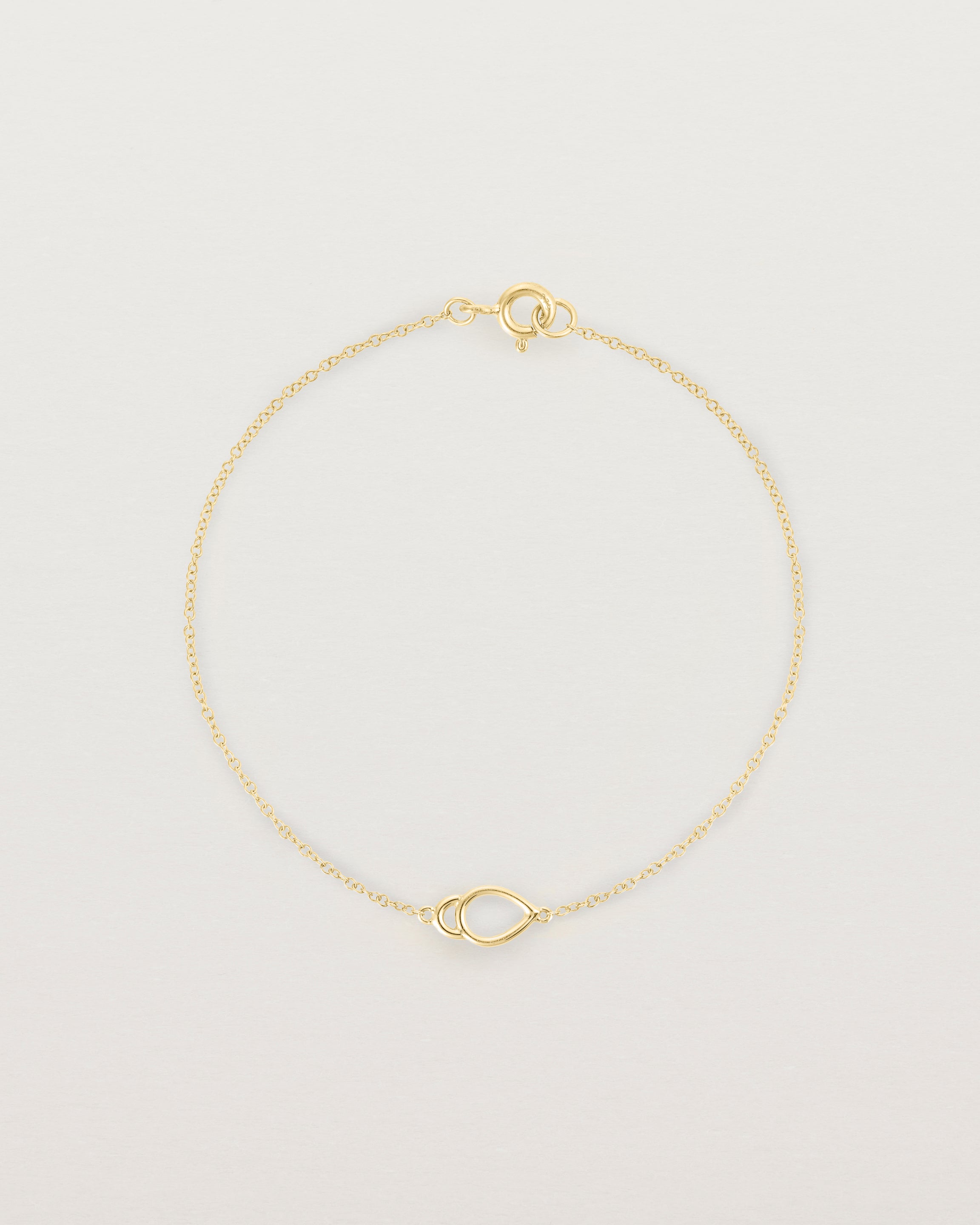 A yellow gold chain with an oval pendant