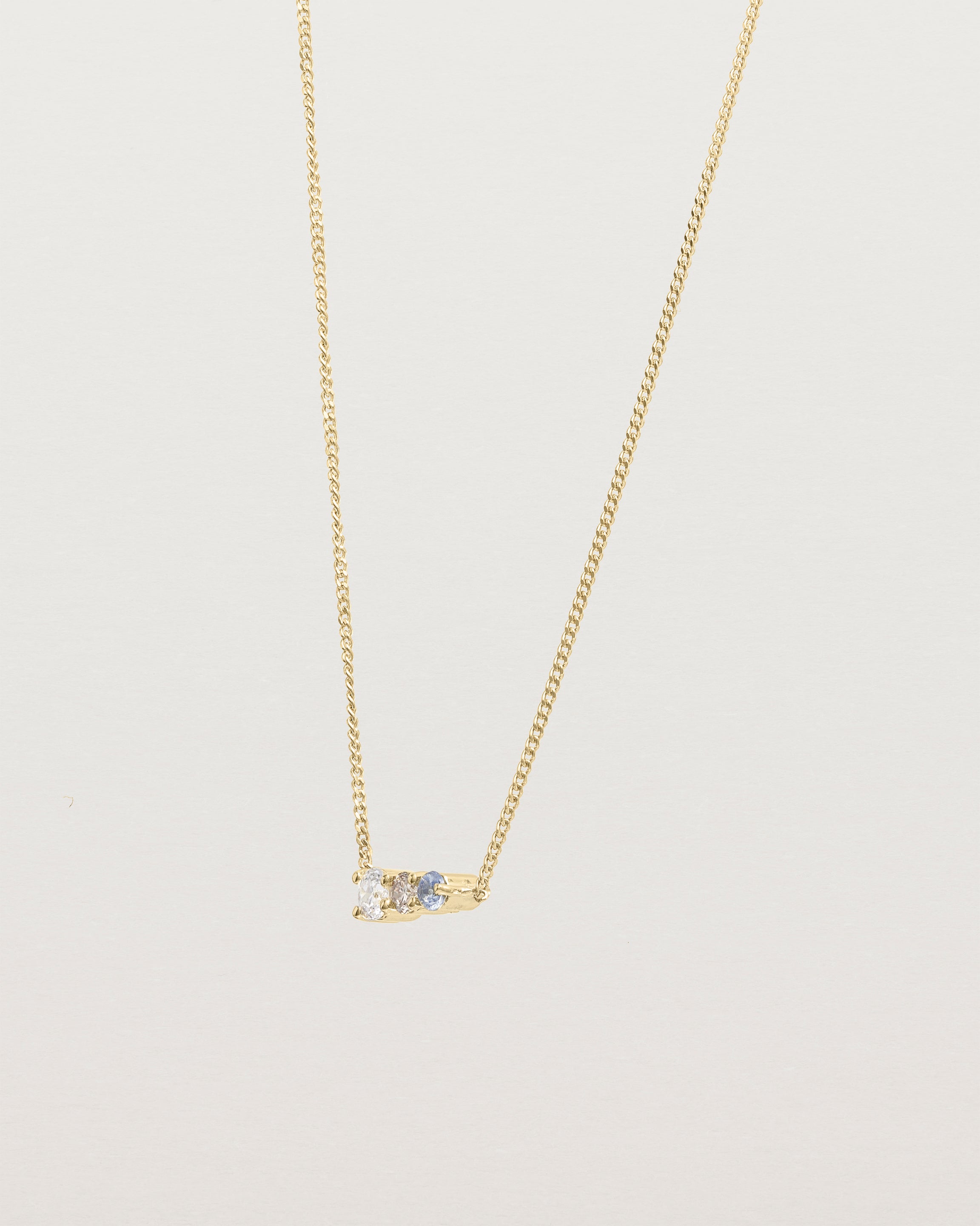 Angled view of the Ode Necklace | Diamond & Sapphire | Yellow Gold