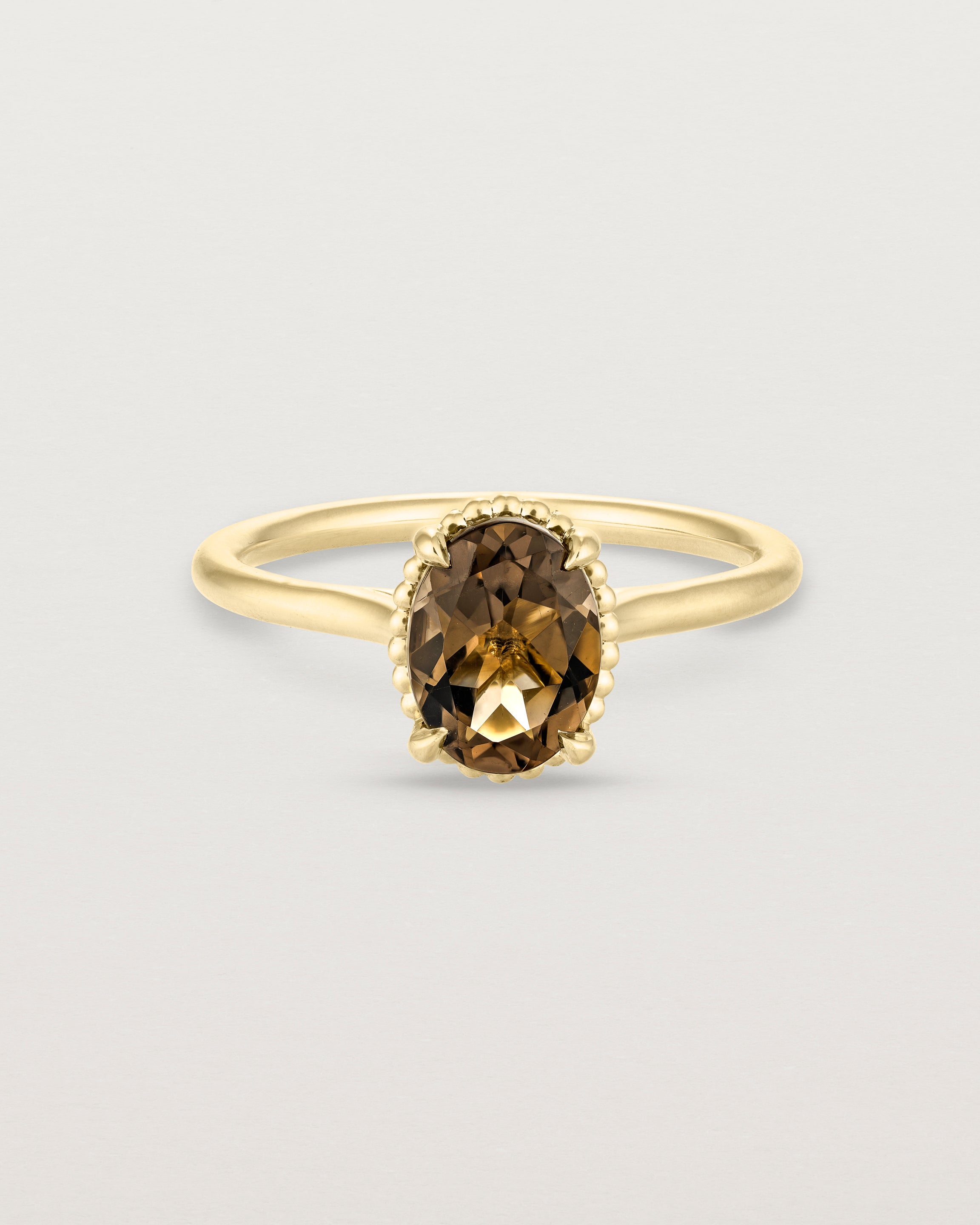 Front view of the Thea Oval Solitaire | Smokey Quartz in yellow gold.