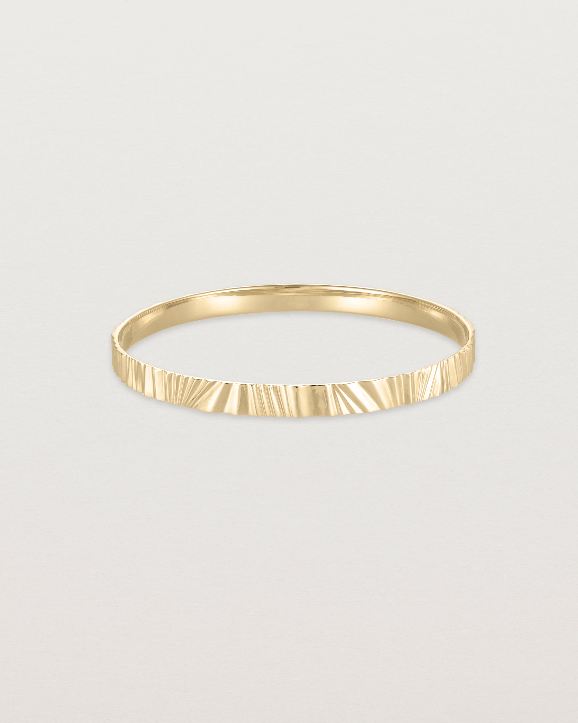 Front view of the Pan Bangle in yellow gold.