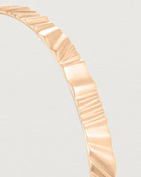 Close up view of the Pan Bangle in rose gold.