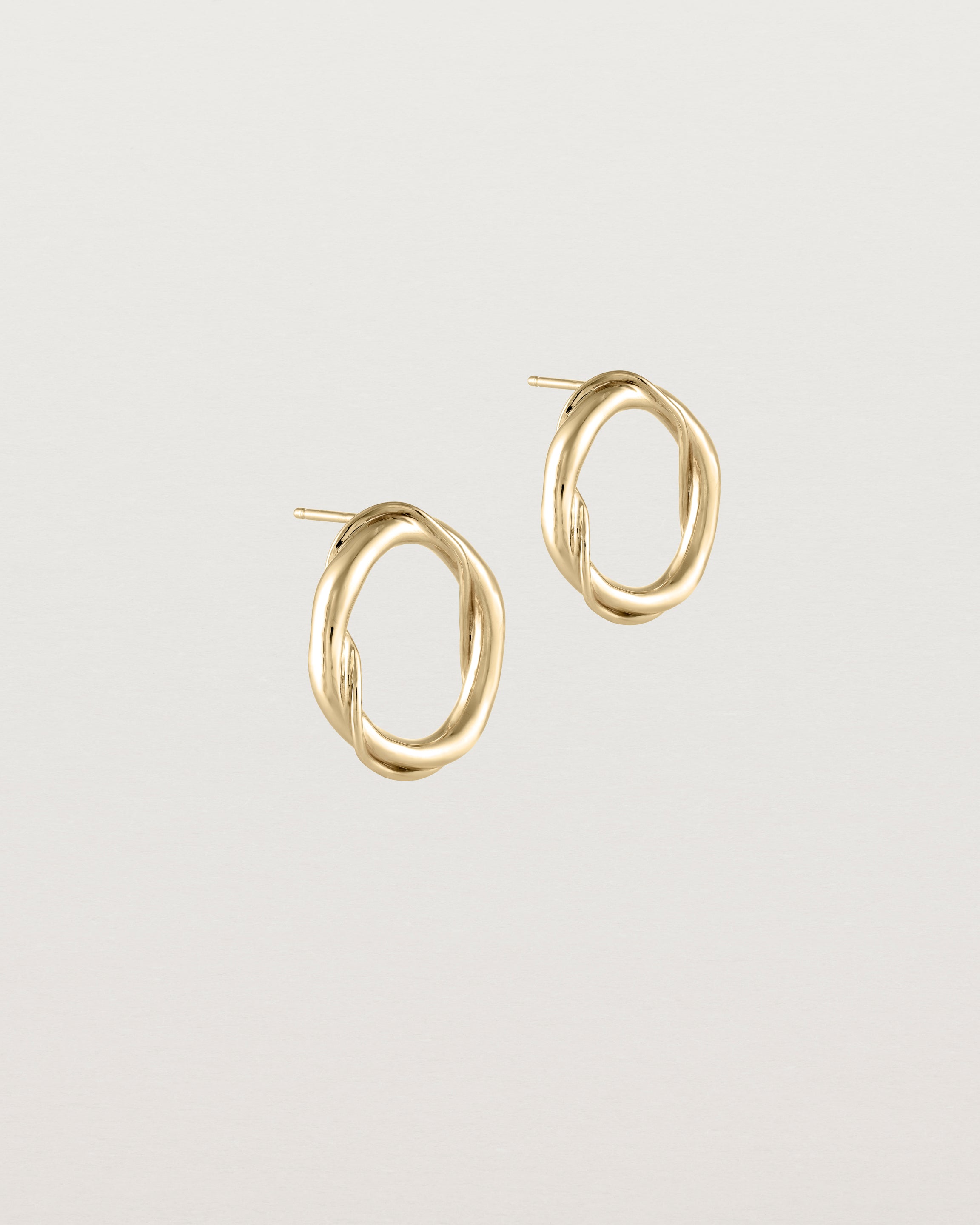 Angled view of the Petite Dalí Earrings in yellow gold.