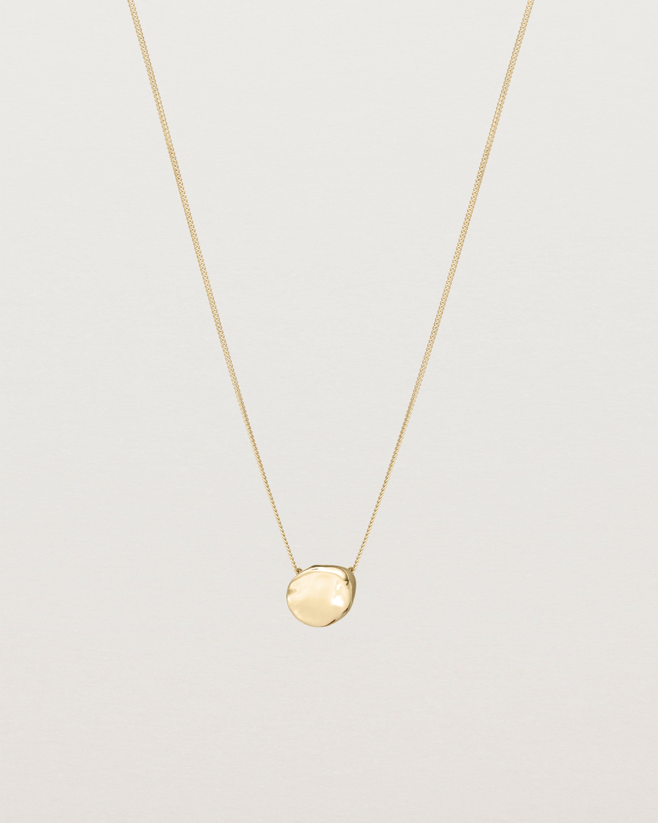 Front view of the Petite Mana Necklace in yellow gold.
