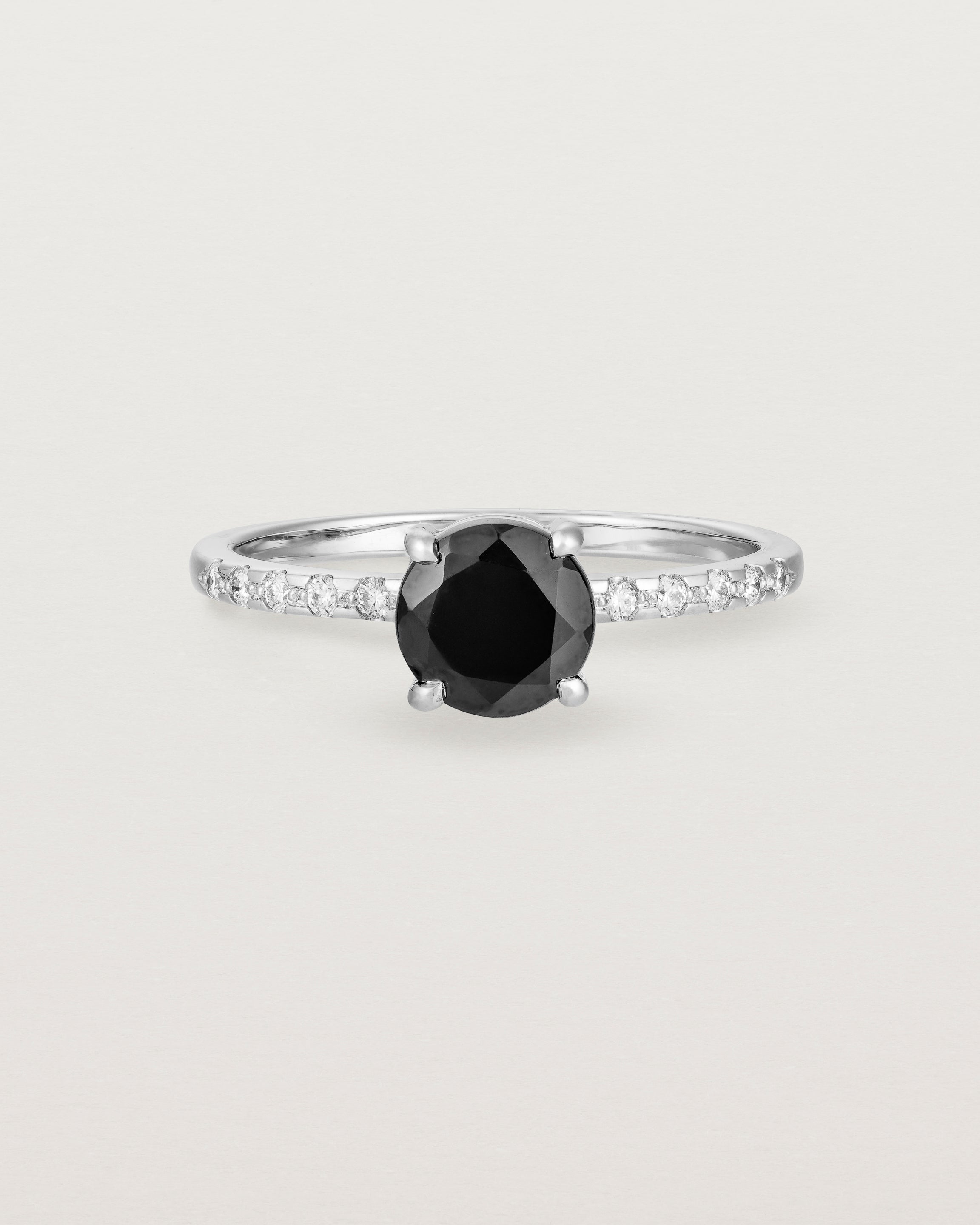 Front view of the Petite Una Round Solitaire | Black Spinel | White Gold with Cascade Shoulders.