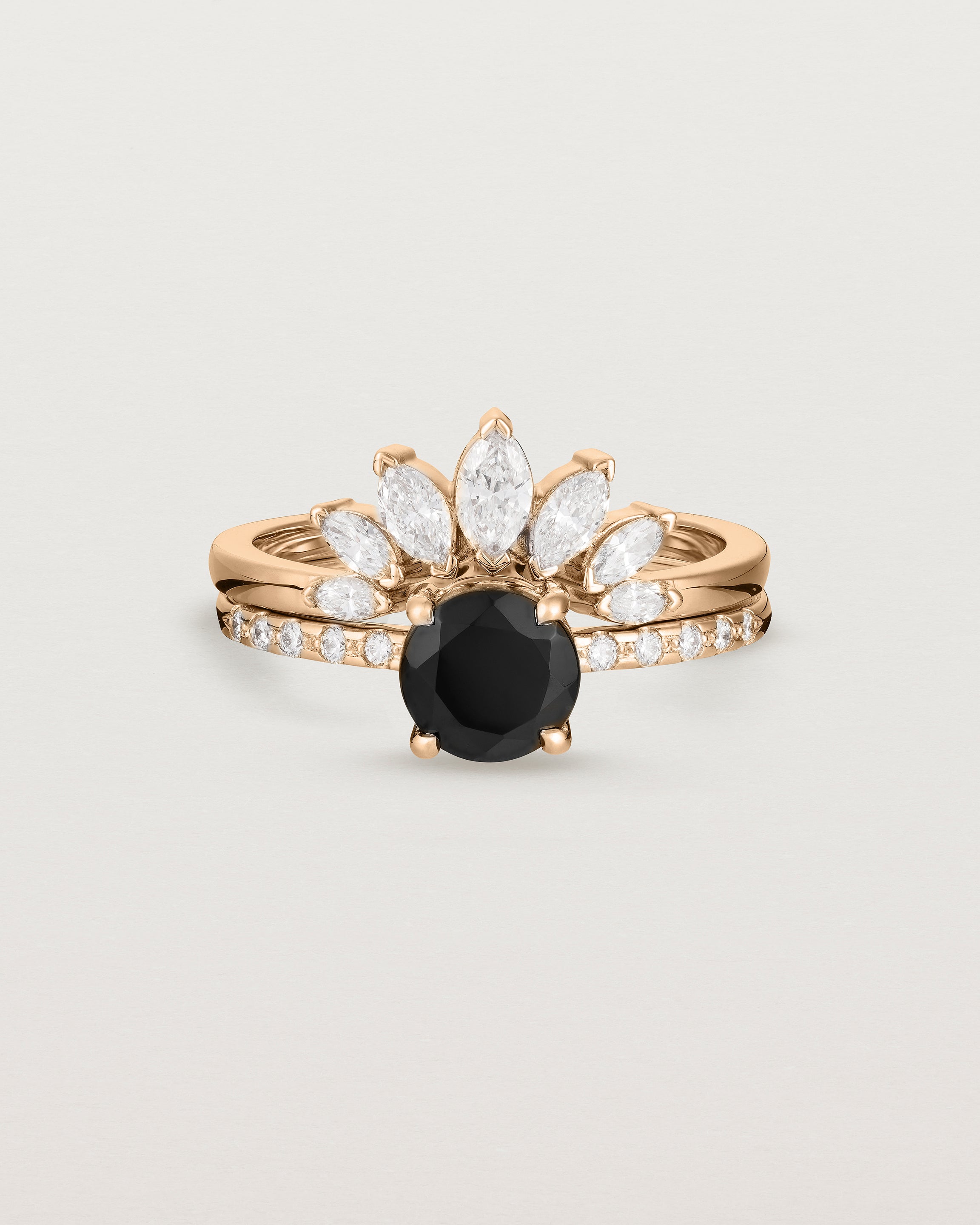 Front view of the Petite Una Round Solitaire | Black Spinel | Rose Gold with Cascade Shoulders stacked with the Camille Crown Ring | Diamonds. 