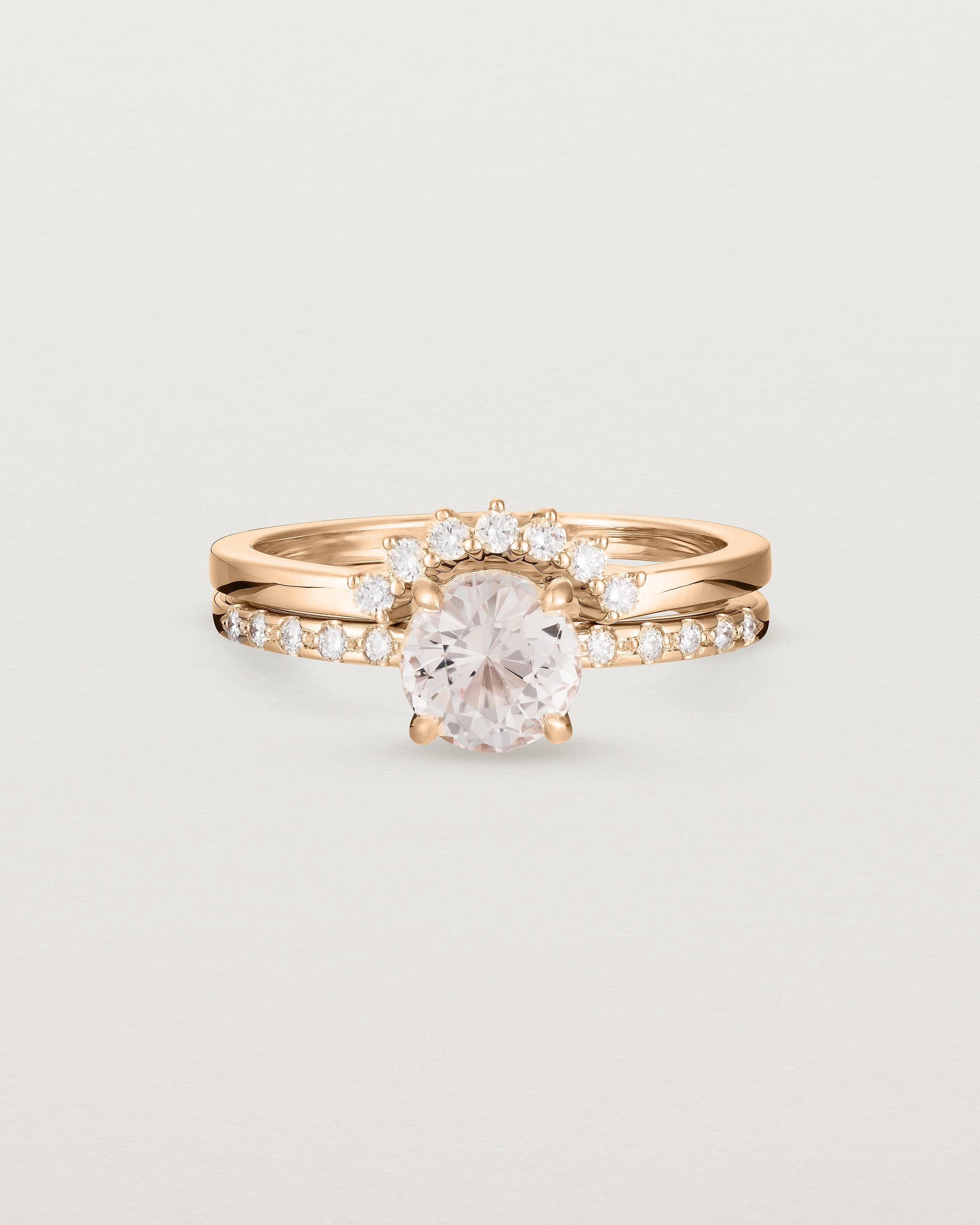 The Petite Una Round Solitaire | Morganite with Cascade Shoulders, stacked with the Reina Crown Ring | Diamonds in Rose Gold.
