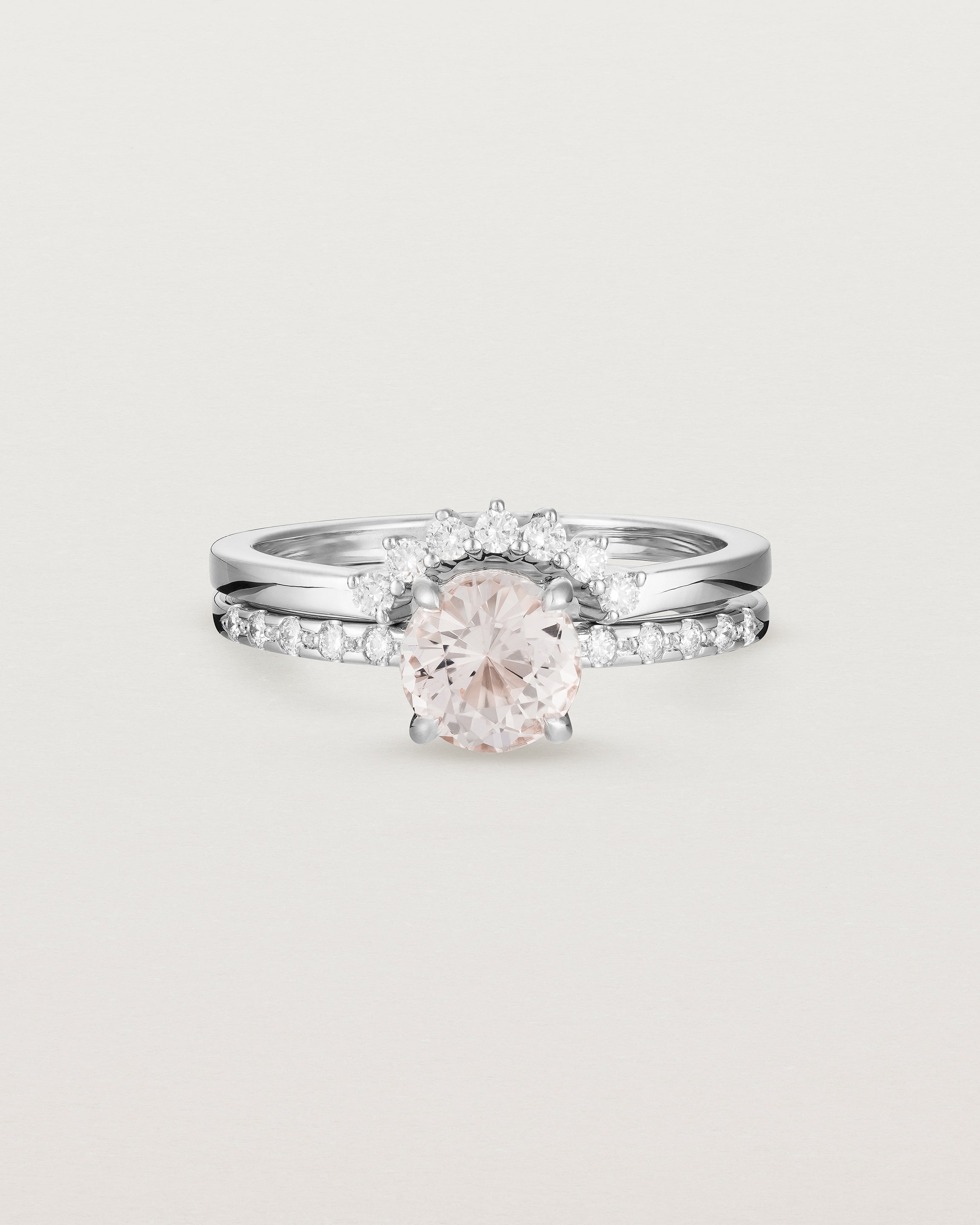 The Petite Una Round Solitaire | Morganite with Cascade Shoulders, stacked with the Reina Crown Ring | Diamonds in White Gold.