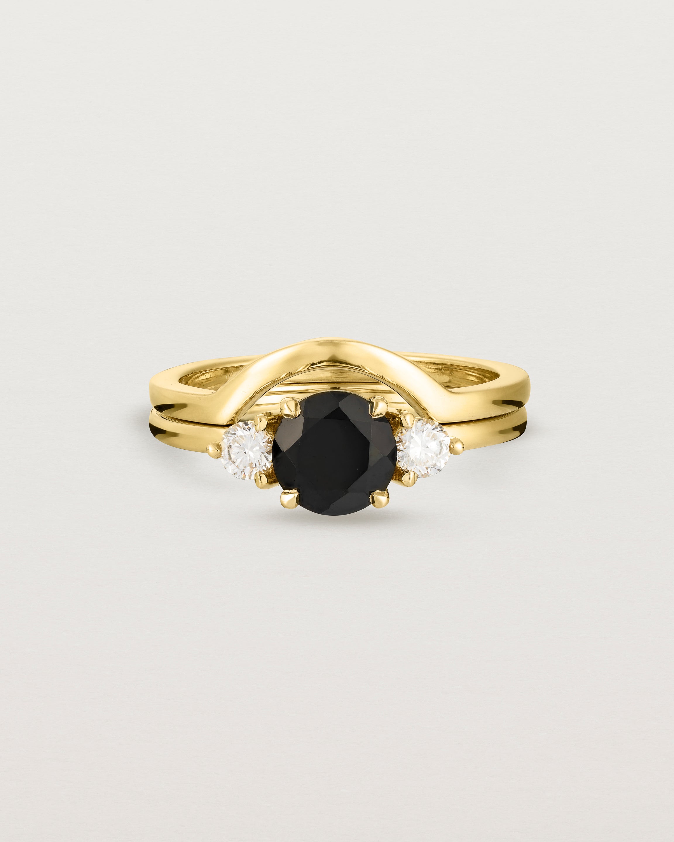Front view of the Petite Una Round Trio Ring | Black Spinel & Diamonds | Yellow Gold stacked with the Cecile Crown Ring.