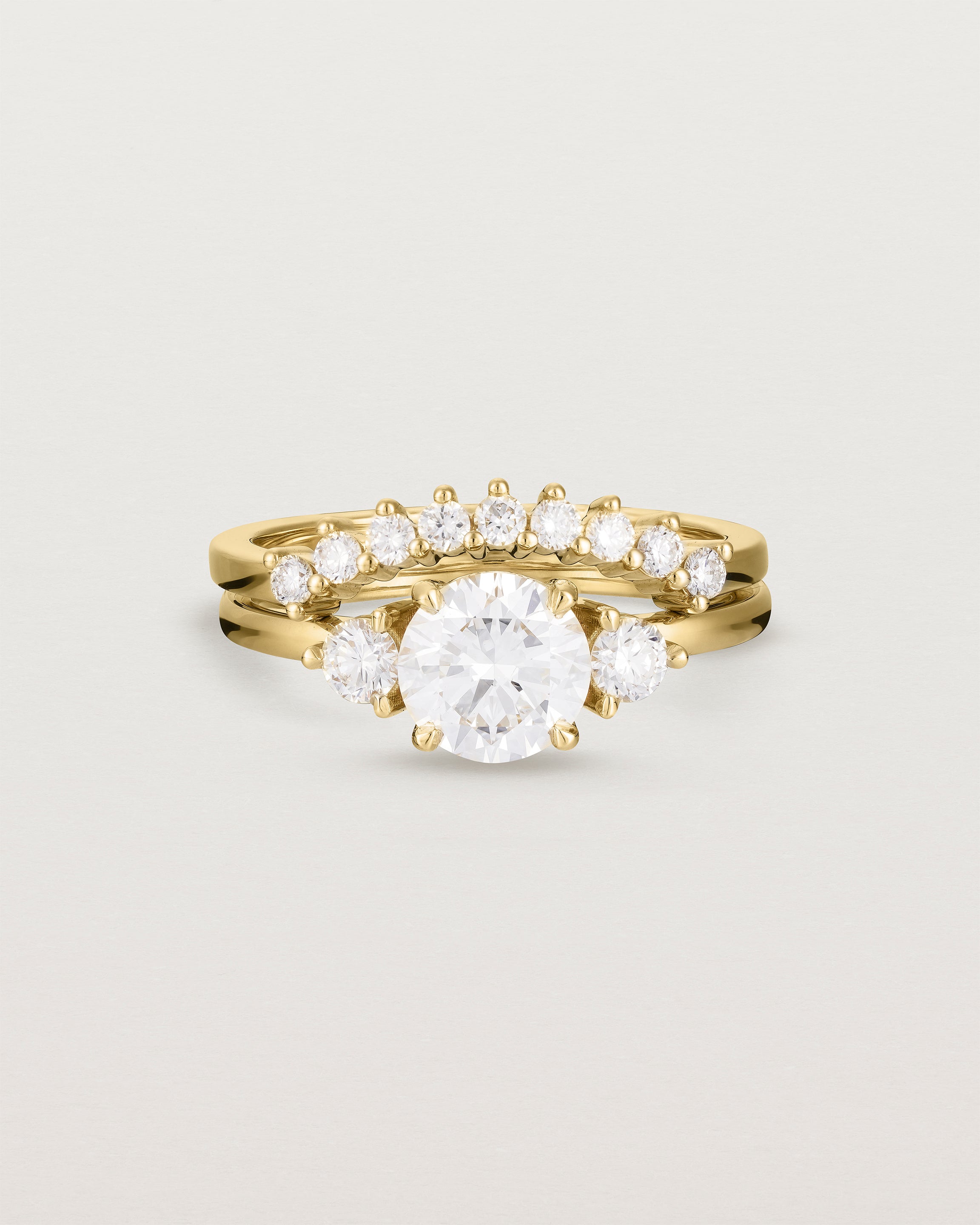 Front view of the Petite Una Round Trio Ring | Laboratory Grown Diamonds | Yellow Gold with the Reina Crown Ring | Diamonds. 