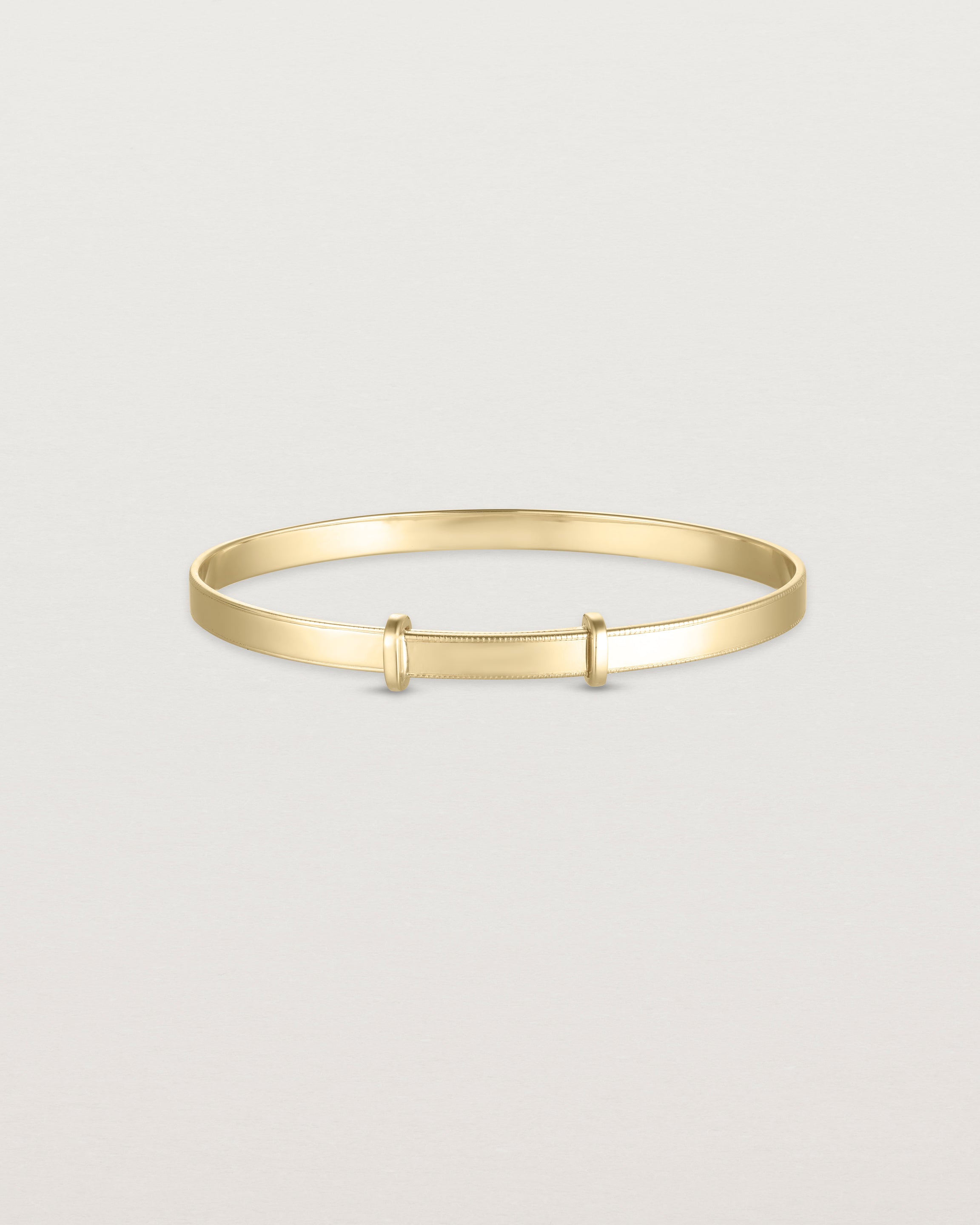 back image of the Toujours bangle millgrain in yellow gold