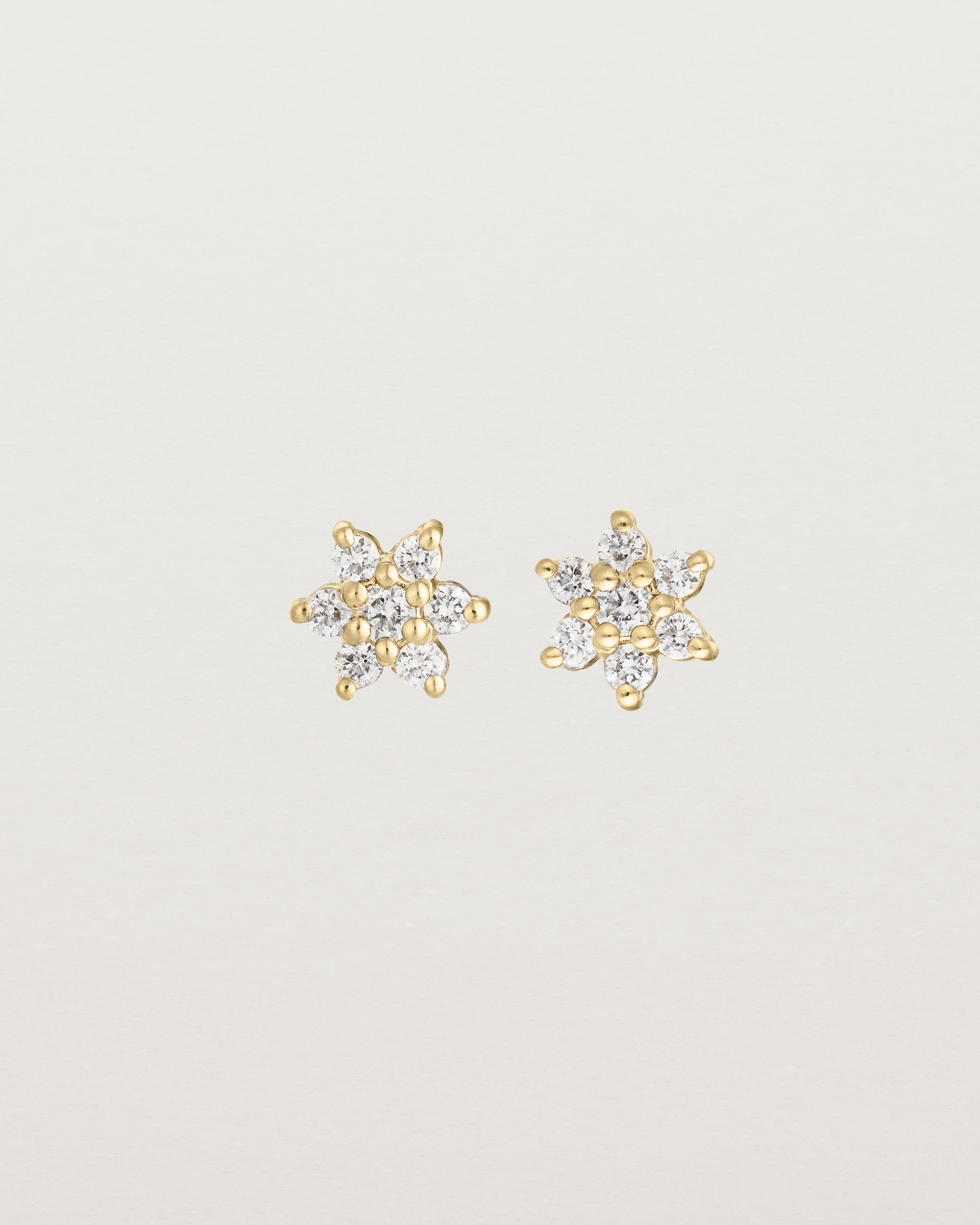 Front image of the petit starburst studs with white diamonds