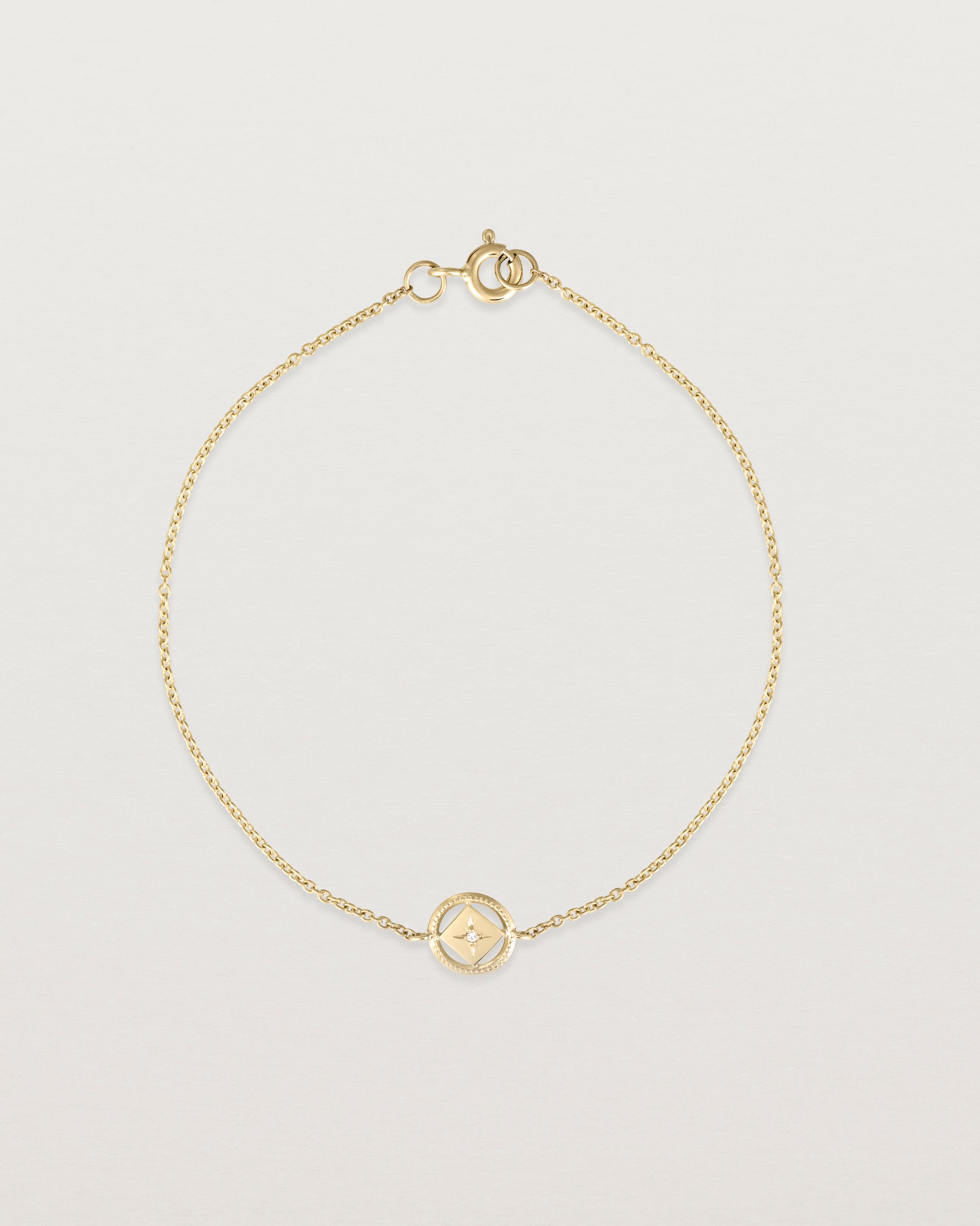 Full view of the Polaris Bracelet | Birthstone in yellow gold with a white diamond.