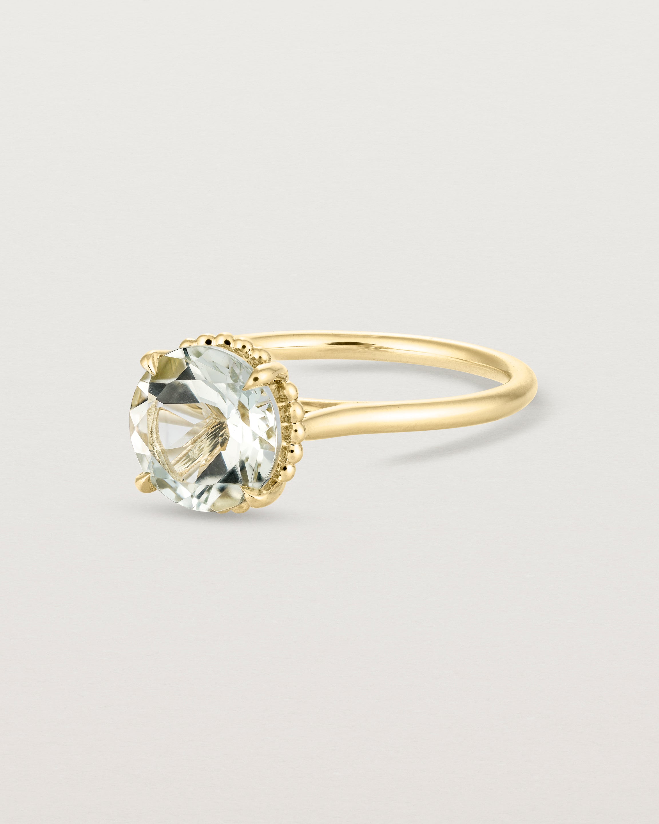 Angled view of the Thea Round Solitaire | Green Amethyst in yellow gold.