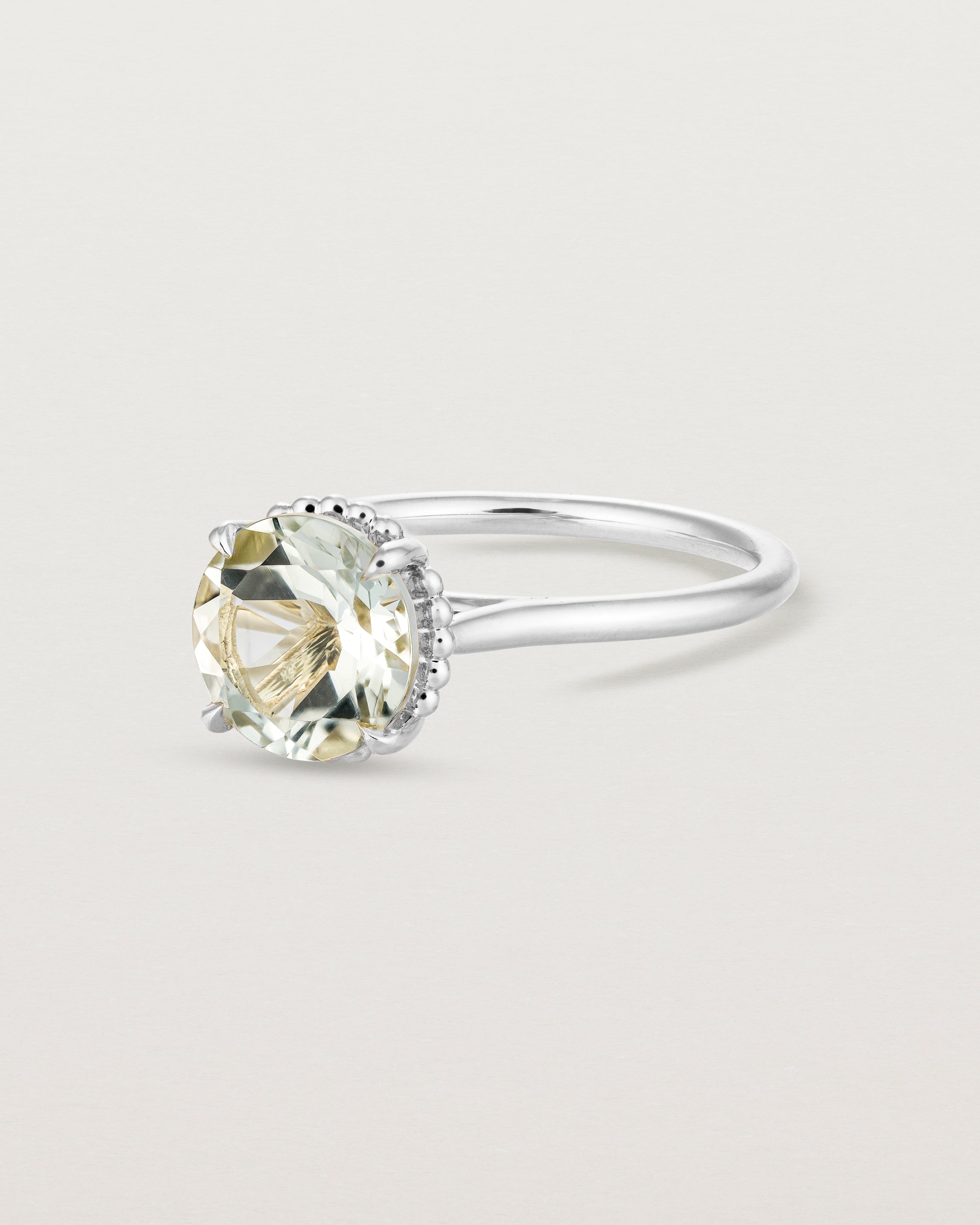 Angled view of the Thea Round Solitaire | Green Amethyst in white gold.