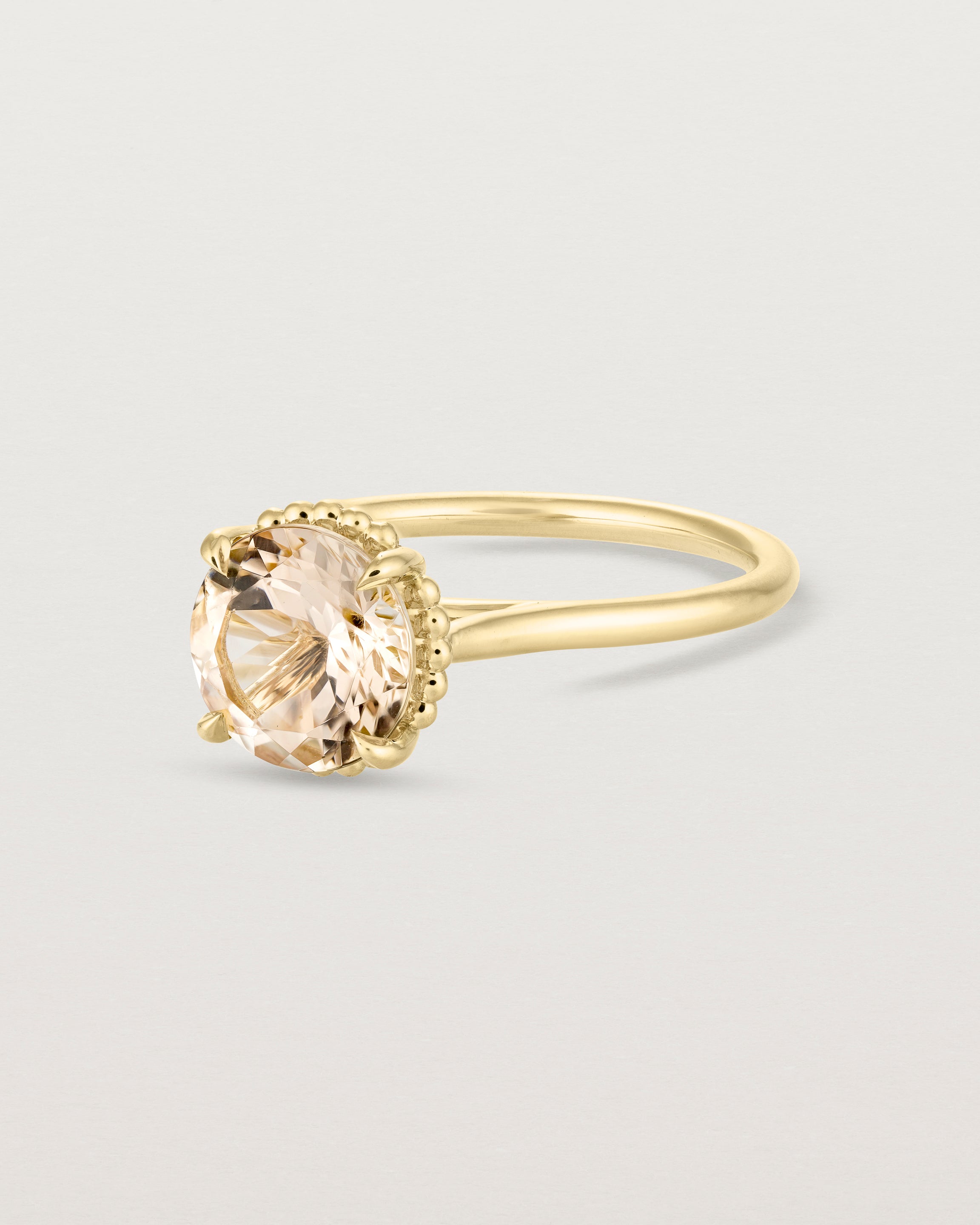Angled view of the Thea Round Solitaire | Savannah Sunstone in yellow gold.