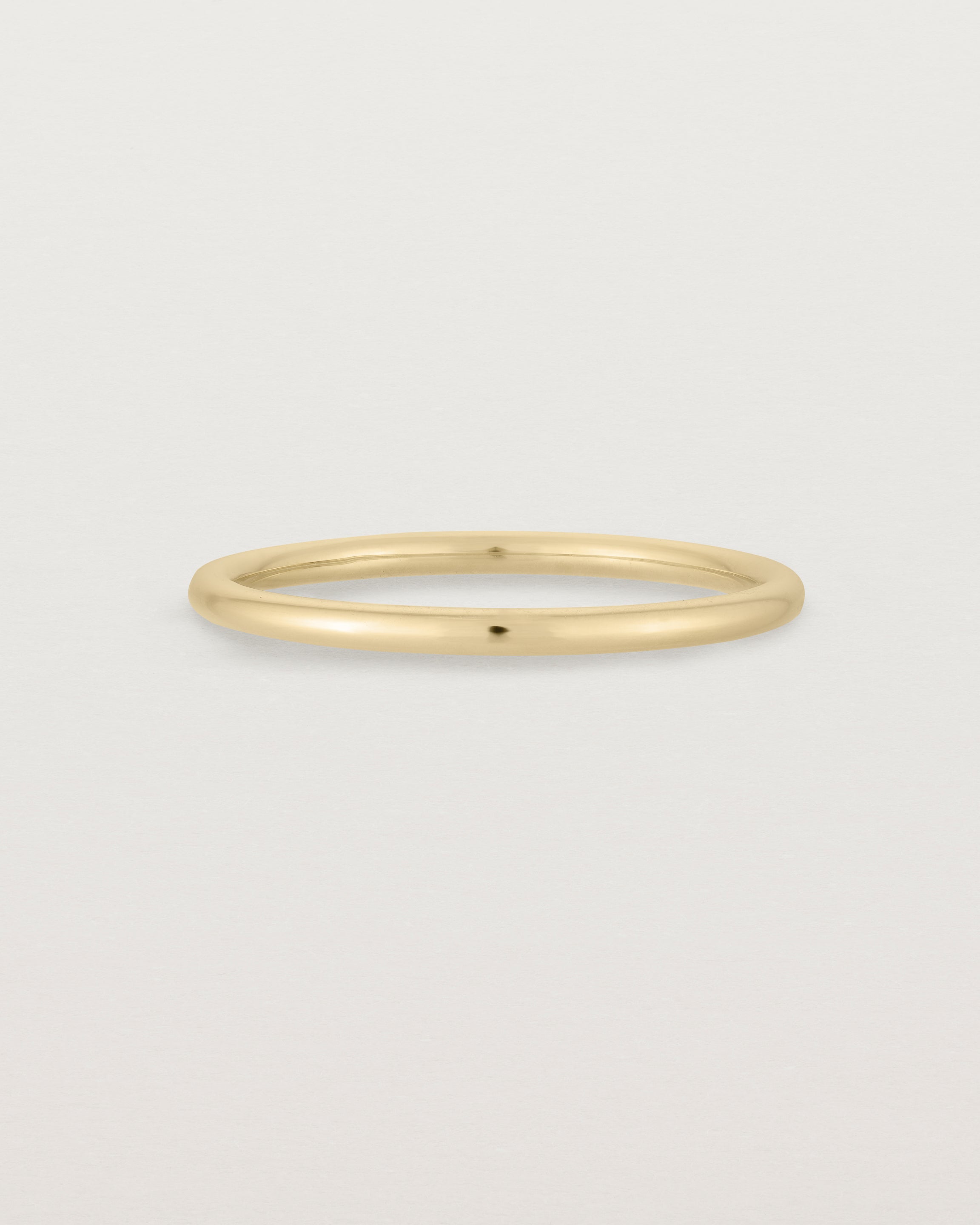 Our fine round wedding band in yellow gold