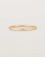 Our fine round wedding band in rose gold