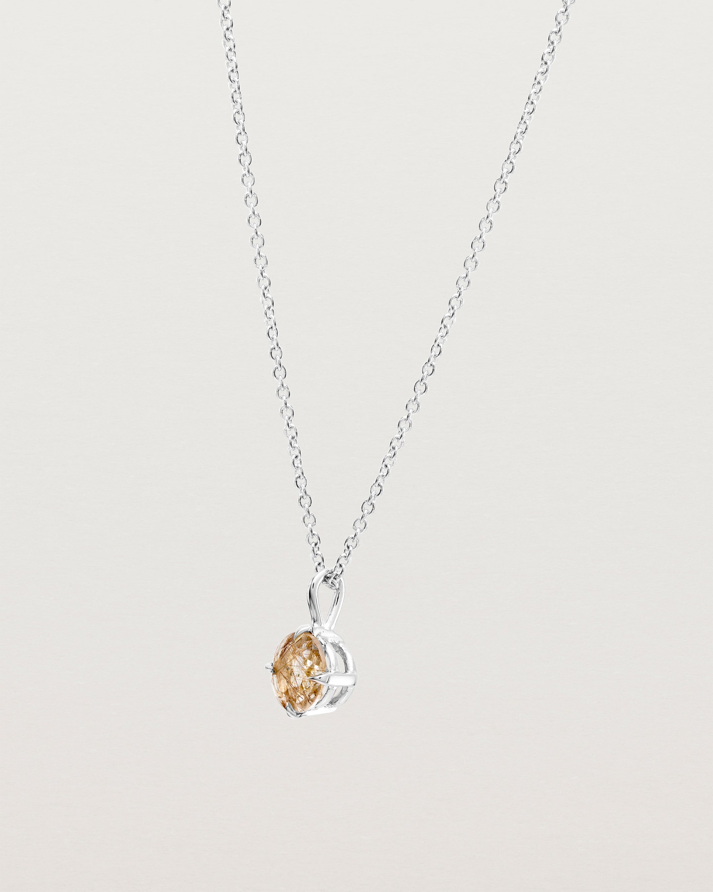 Angled view of the Una Necklace | Rutilated Quartz | Sterling Silver.