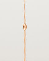 close up view of Sonder bracelet in rose gold showing one charm