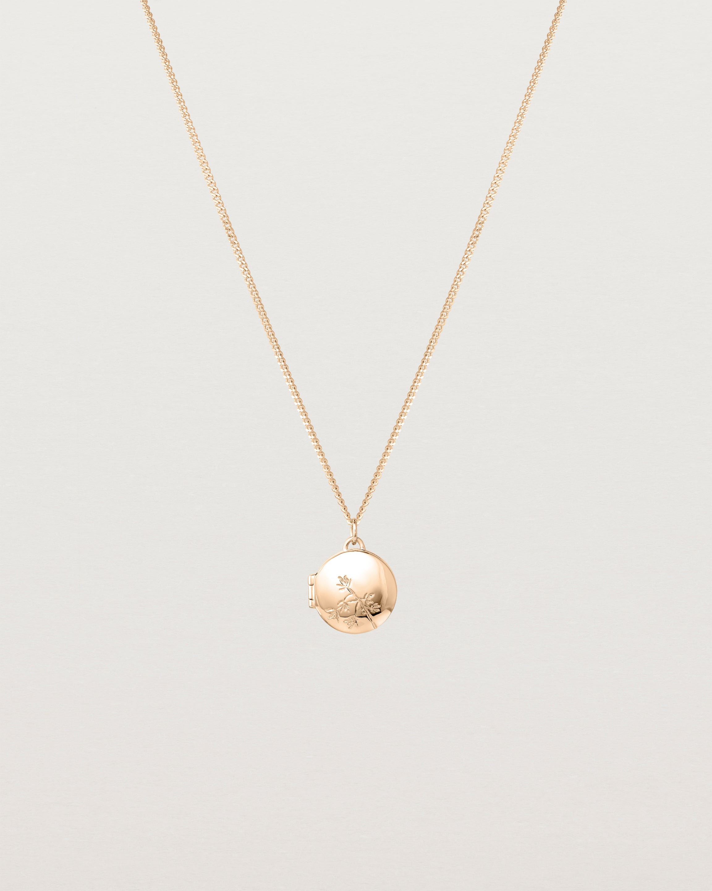 Front view of the Spotted Orchid Locket in rose gold.