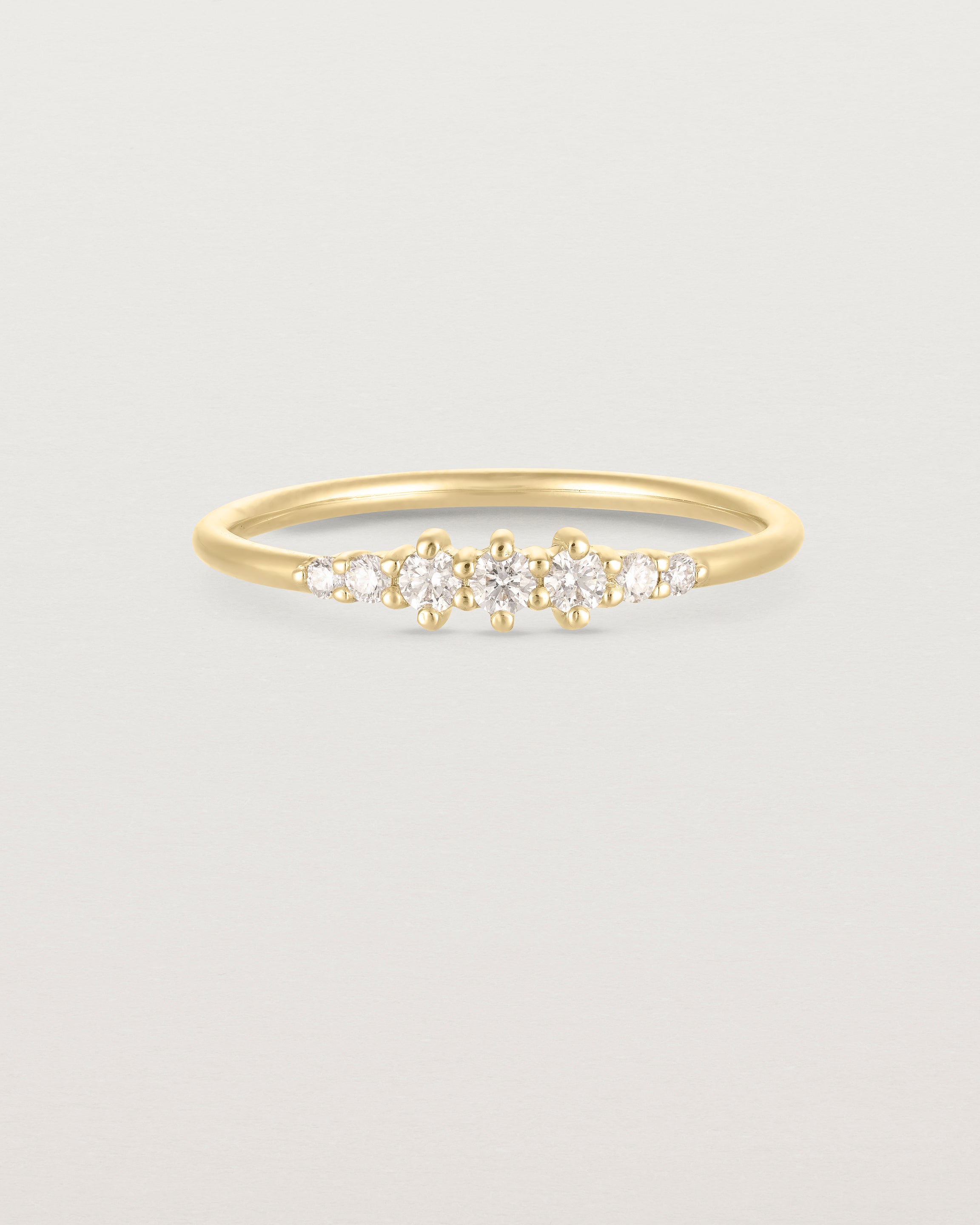Front facing deep etched image of a yellow gold ring with diamonds.