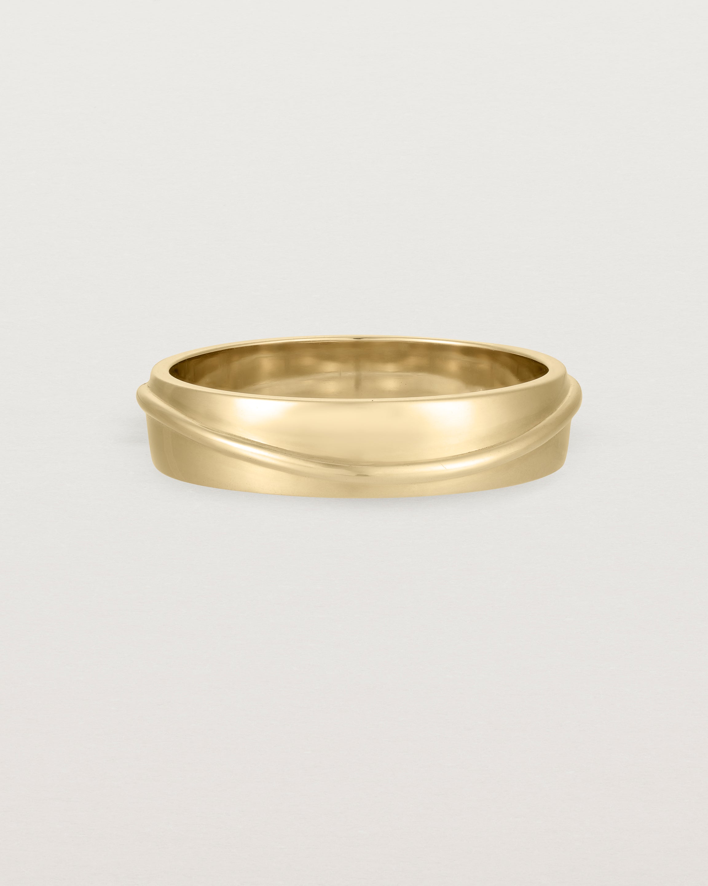 Side view of the Surge Wedding Ring | 5mm | Yellow Gold.