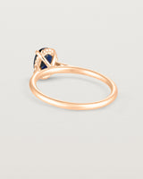 A back view of the Thea Oval Solitaire with a dark blue Australian Sapphire in Rose Gold. 