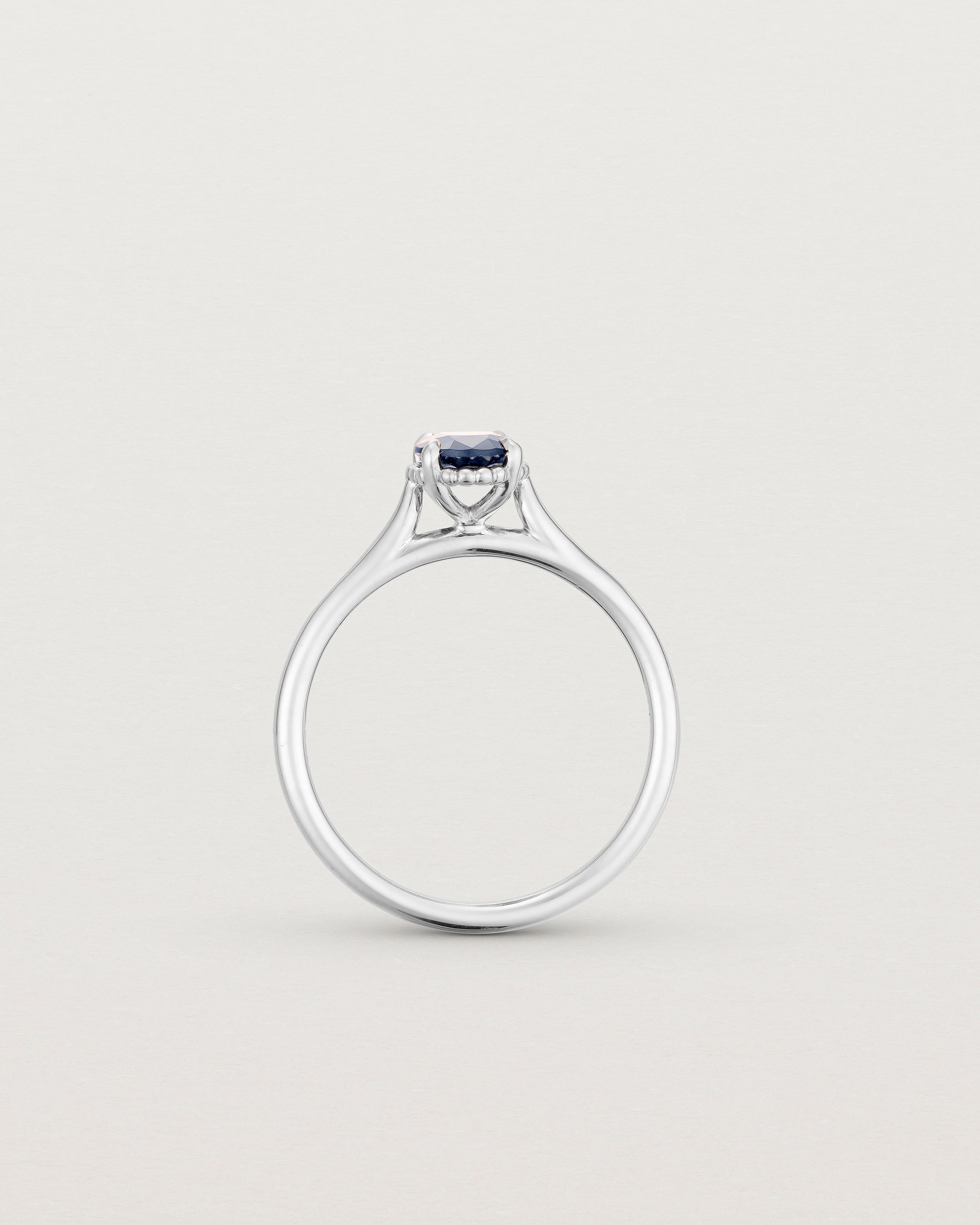 A side profile of the Thea Oval Solitaire with a deep blue Australian Sapphire set in White Gold