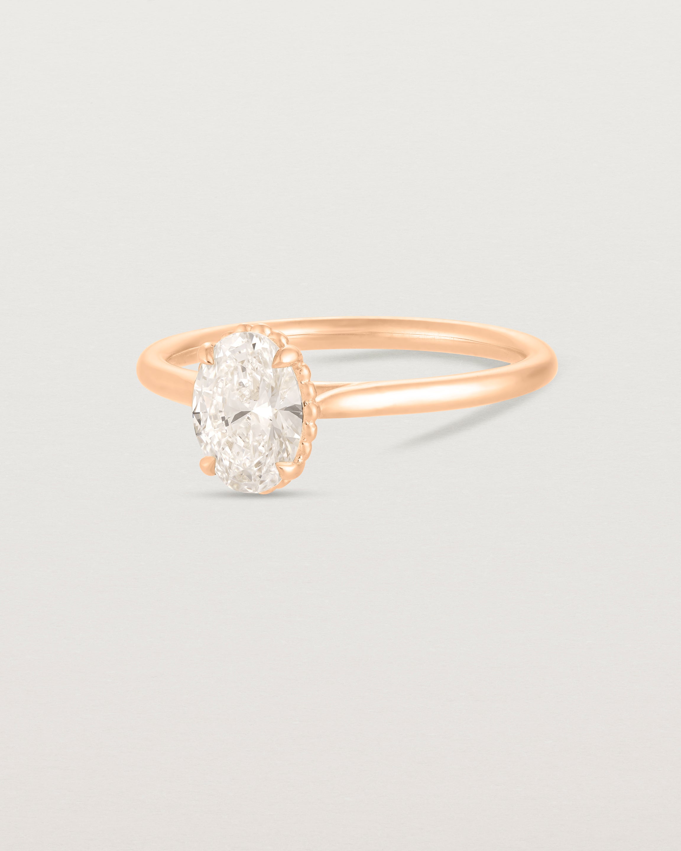 A side view of the Thea Oval Solitaire with a white Laboratory Grown Diamond in Rose Gold