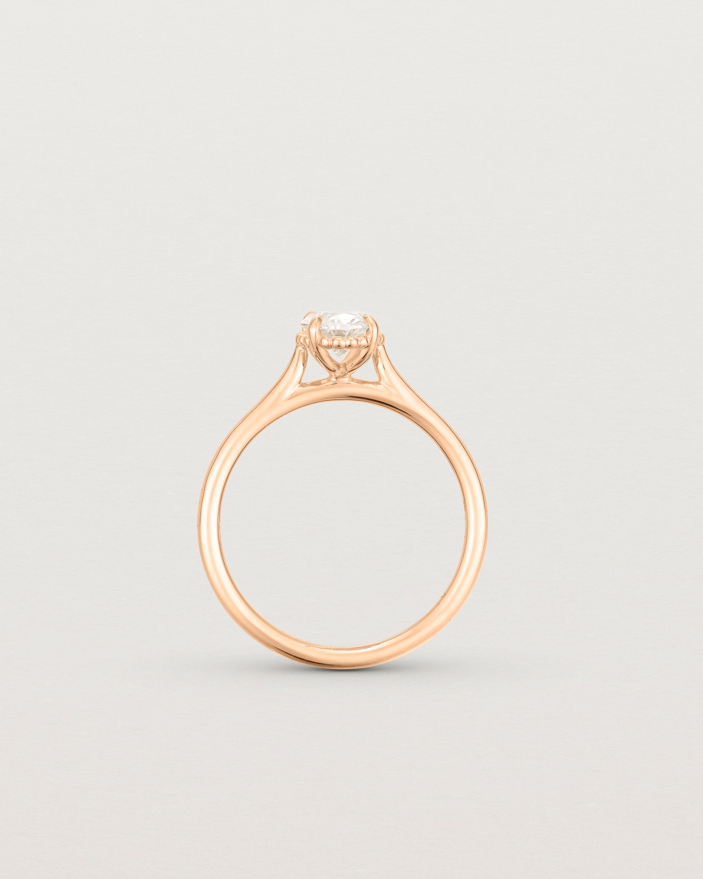 A side profile of the Thea Oval Solitaire with a white Laboratory Grown Diamond in Rose Gold