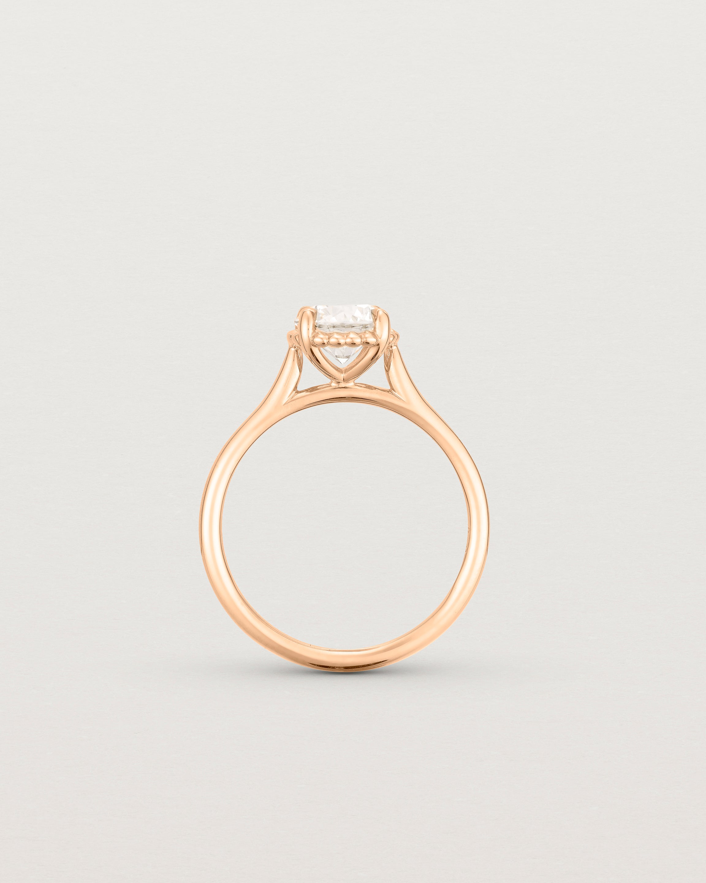 A side profile of the Thea Round Solitaire with a white Laboratory Grown Diamond in Rose Gold