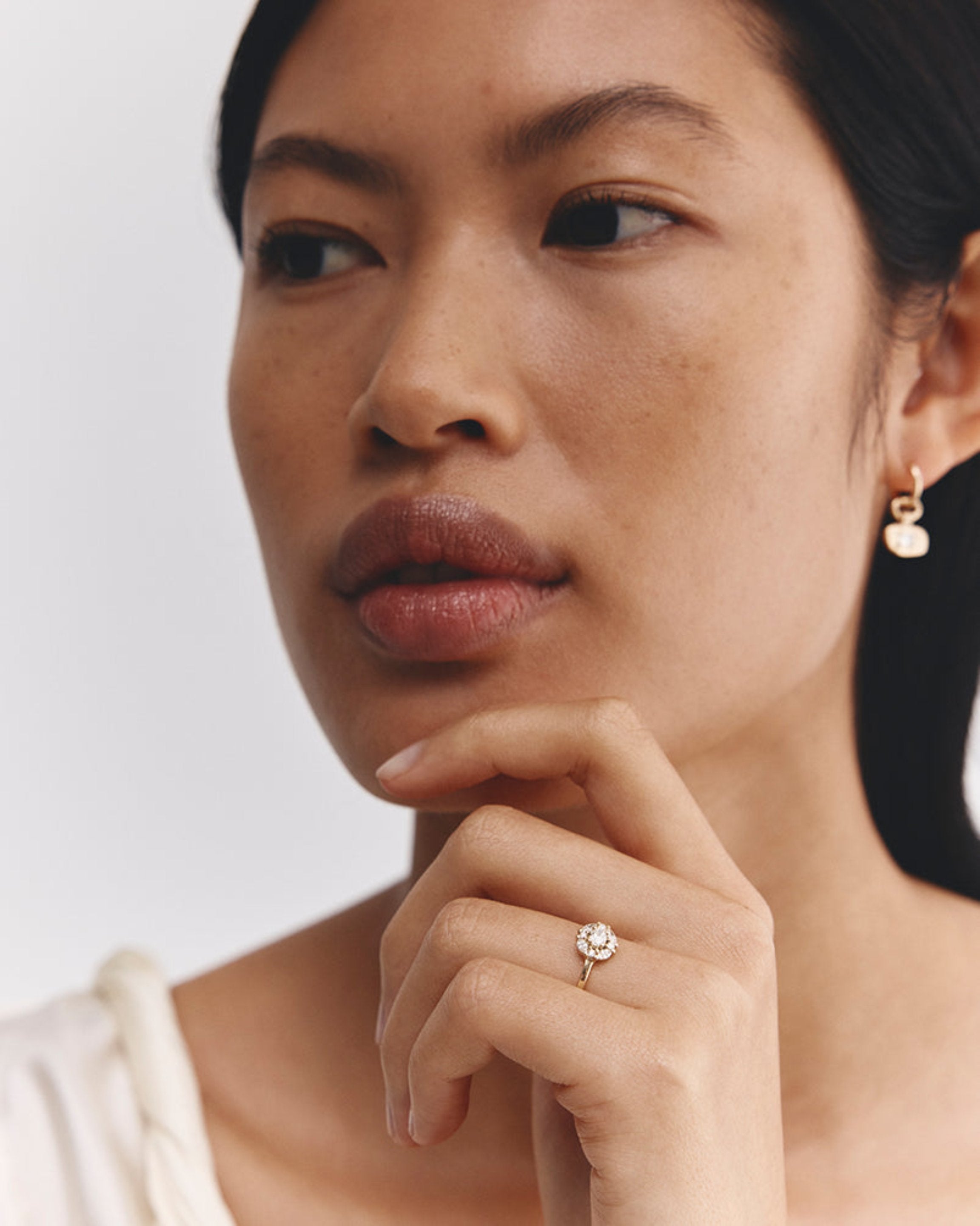 Model wears Tilly Halo ring | Diamonds in yellow gold.