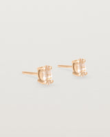 A pair of rose gold studs featuring a marquise shaped light yellow rutilated quartz