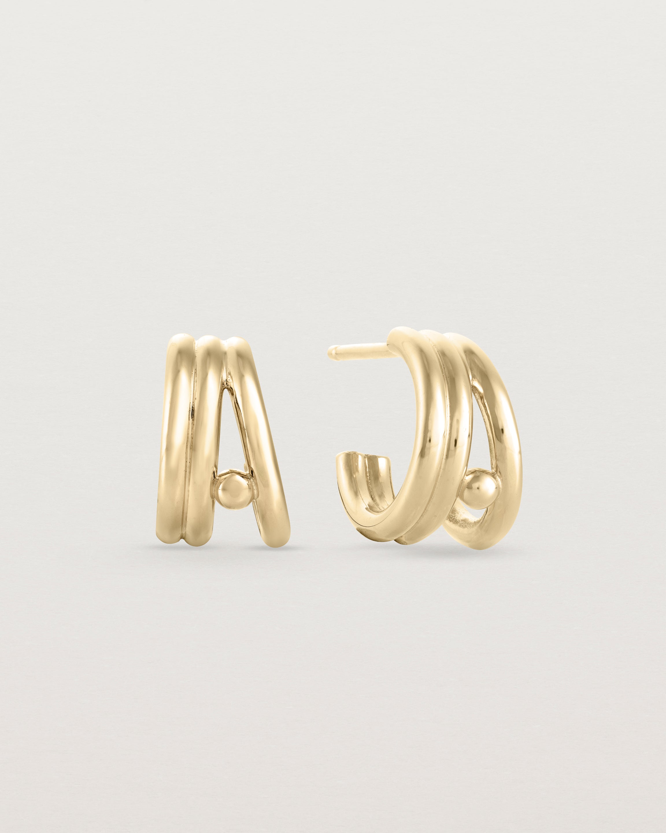 Front view of a pair of Triple Reliquum Hoops in yellow gold.