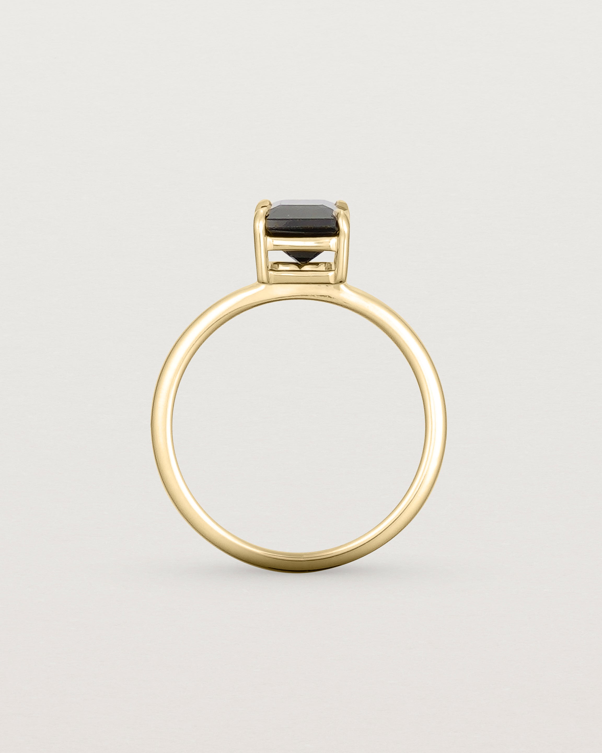 Standing view of the Una Emerald Solitaire | Black Spinel | Yellow Gold.