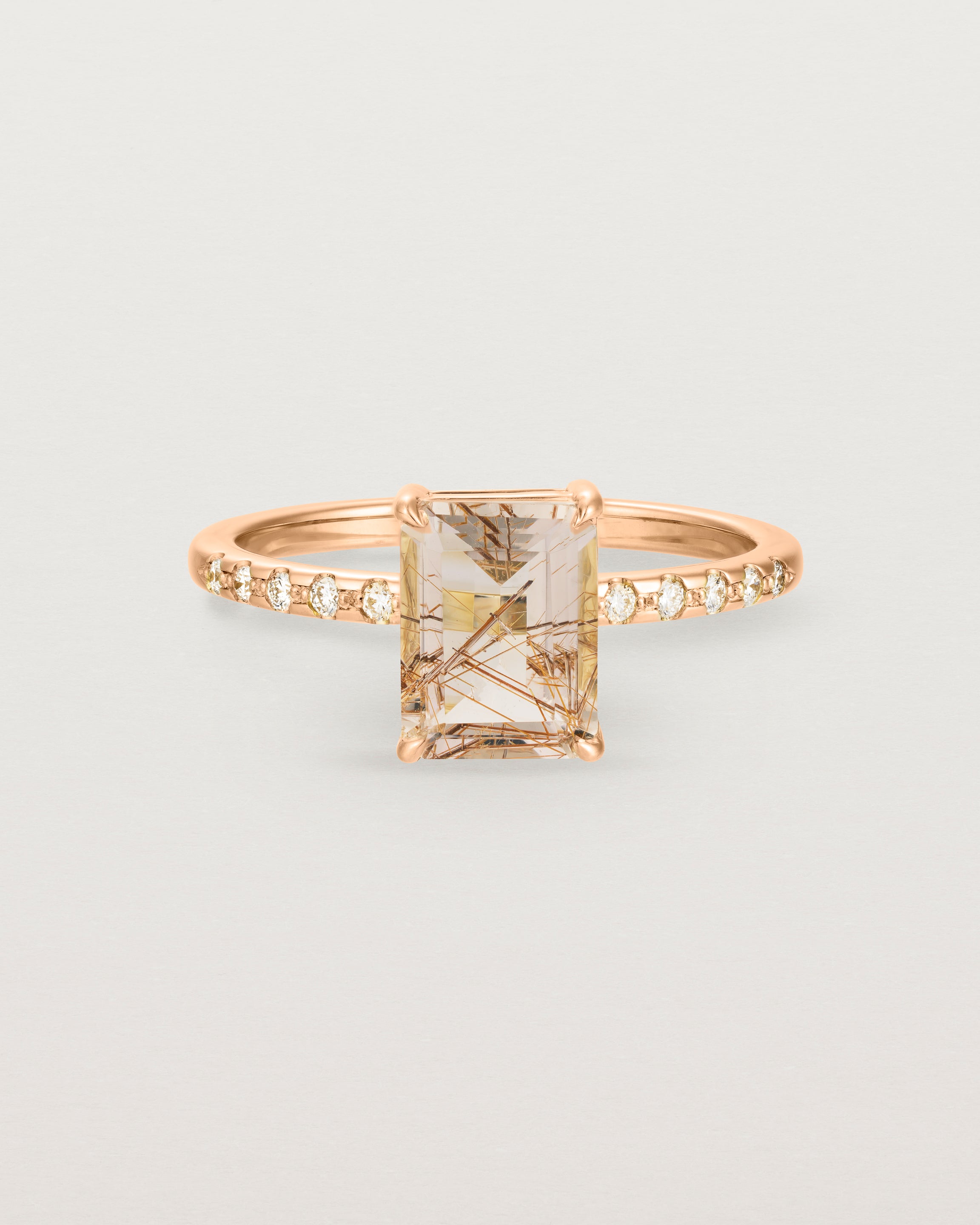 Front view of the Una Emerald Solitaire | Rutilated Quartz | with white diamond shoulders in rose gold.