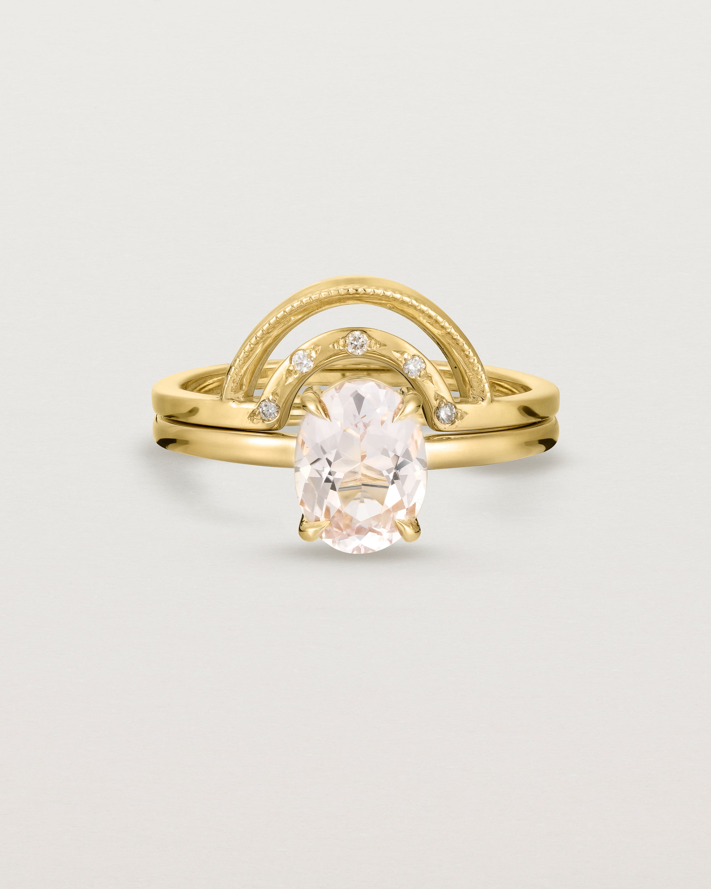 Front view of the Una Oval Solitaire | Morganite | Yellow Gold stacked with the Evette Crown Ring.