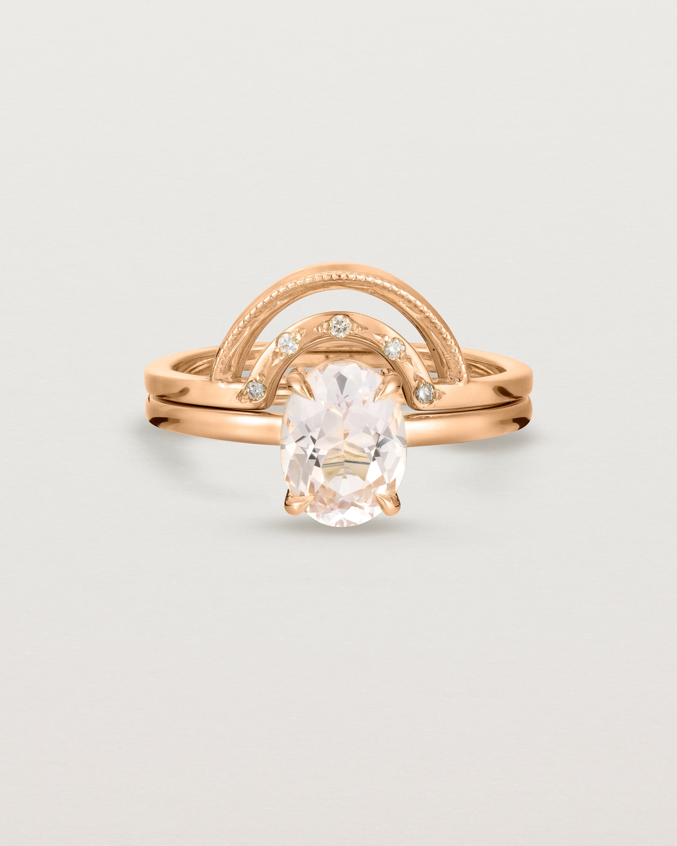 Front view of the Una Oval Solitaire | Morganite | Rose Gold stacked with the Evette Crown Ring.