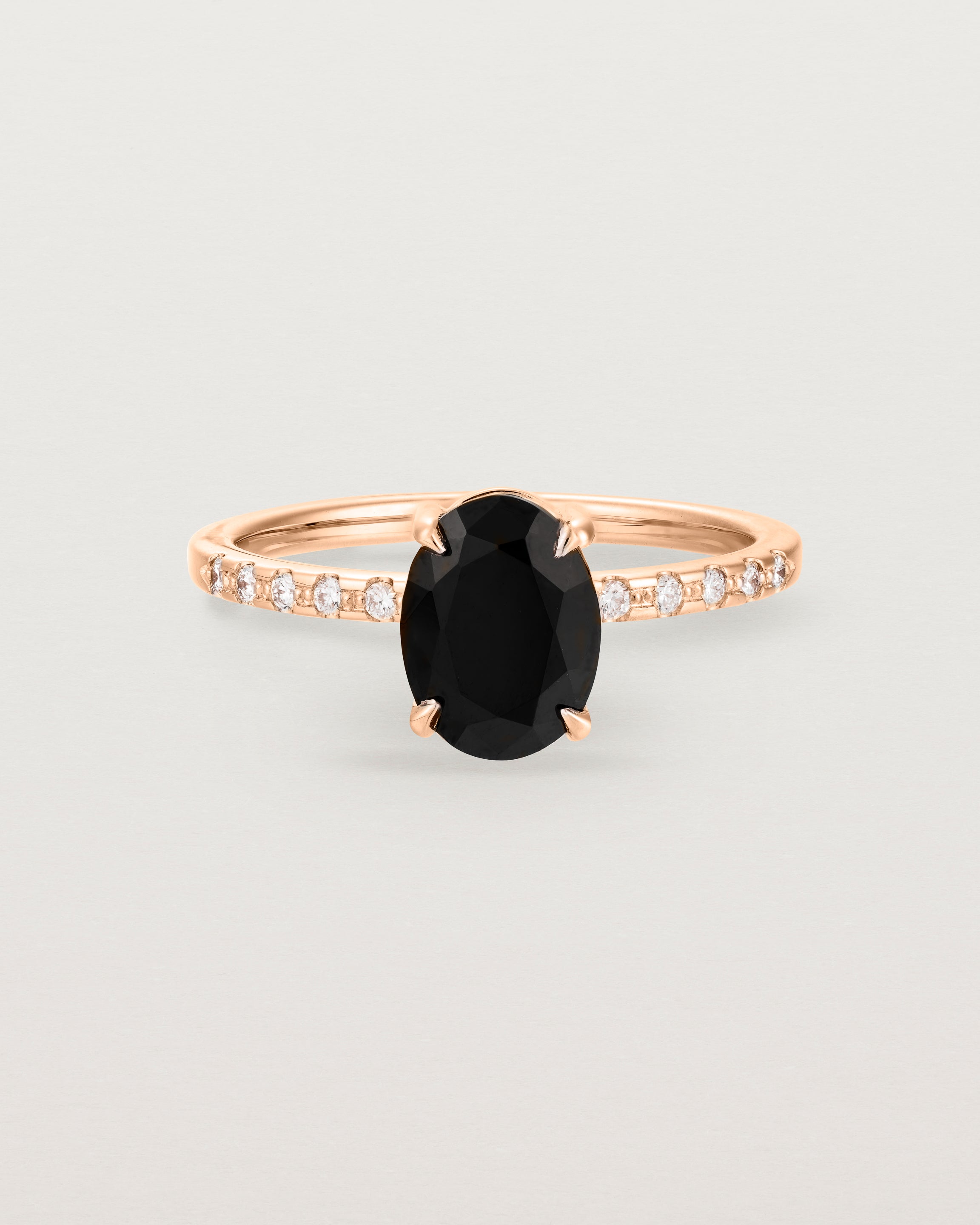 Front view of the Una Oval Solitaire | Black Spinel | Rose Gold with Cascade Shoulders.