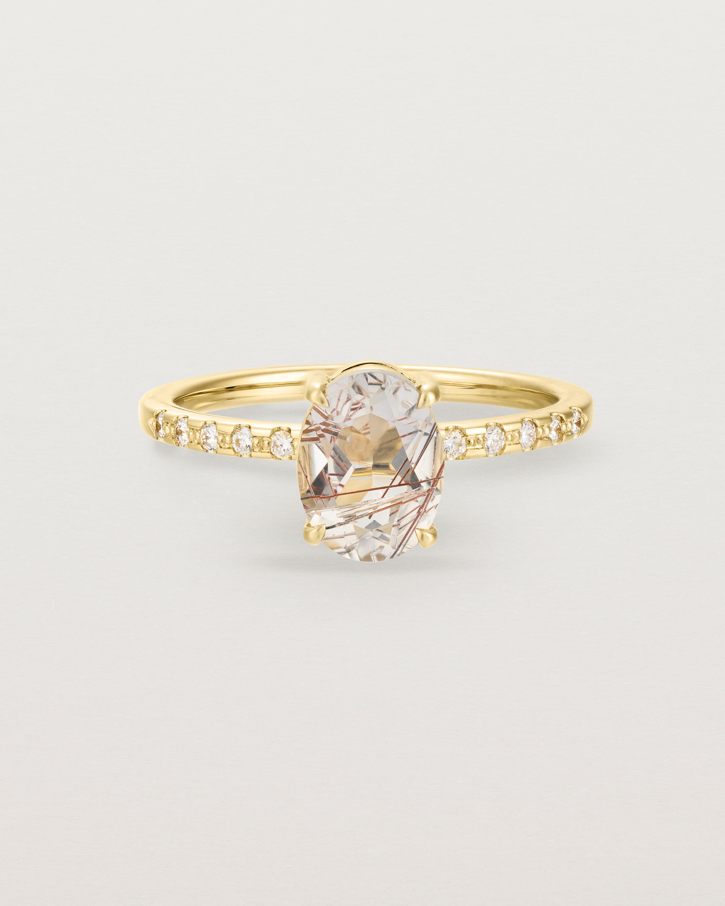 Front view of the Una Oval Solitaire | Rutilated Quartz | Yellow Gold with Cascade Diamond shoulders.